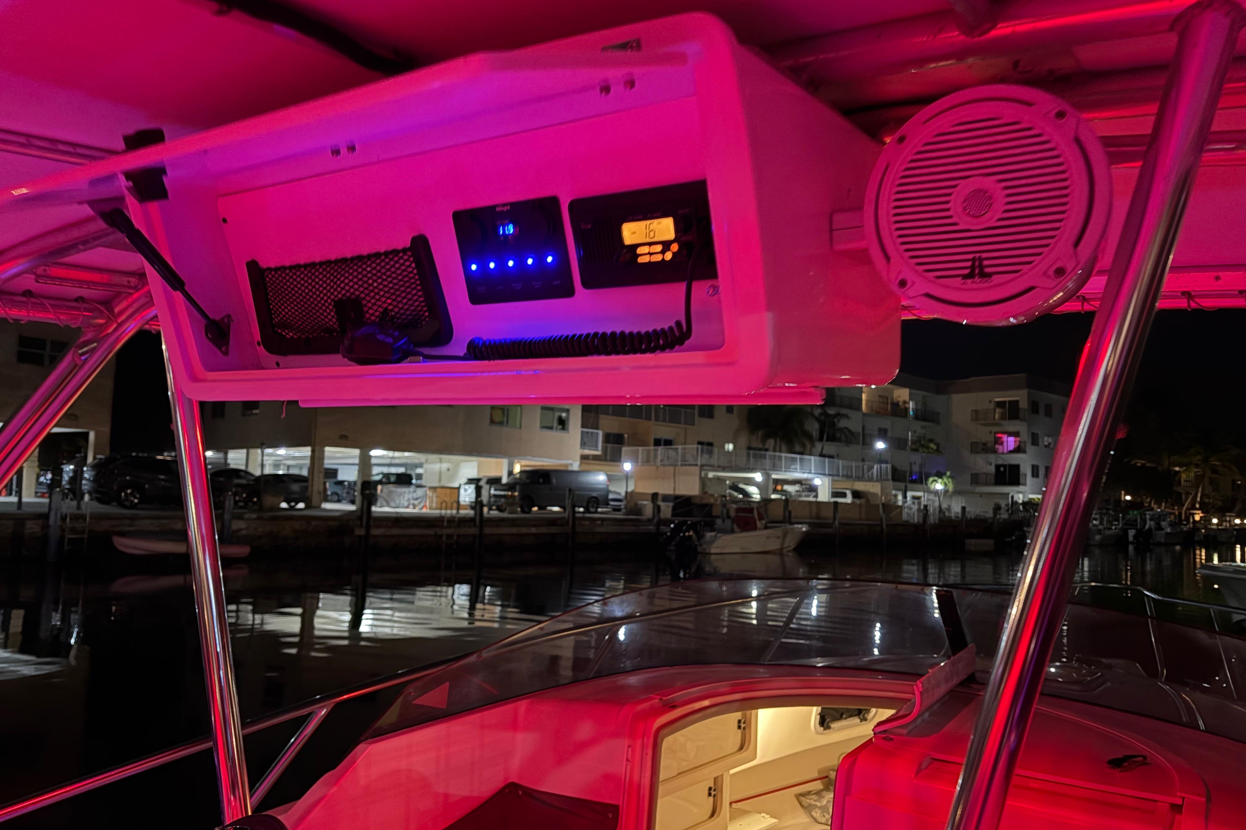 1998 Intrepid 339 Walkaround boat interior with illuminated control panel and speaker at night.