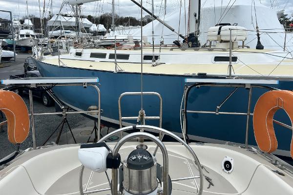 1983 O'Day 39 sailboat in marina, featuring cockpit and nearby vessels.