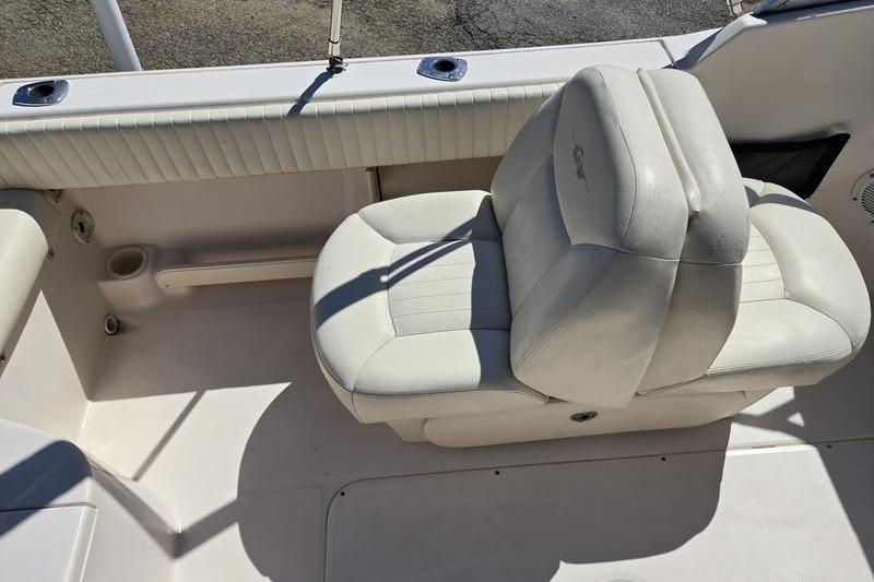 2007 Grady-White Tournament 205 boat seat, featuring white cushioned upholstery and cup holder.