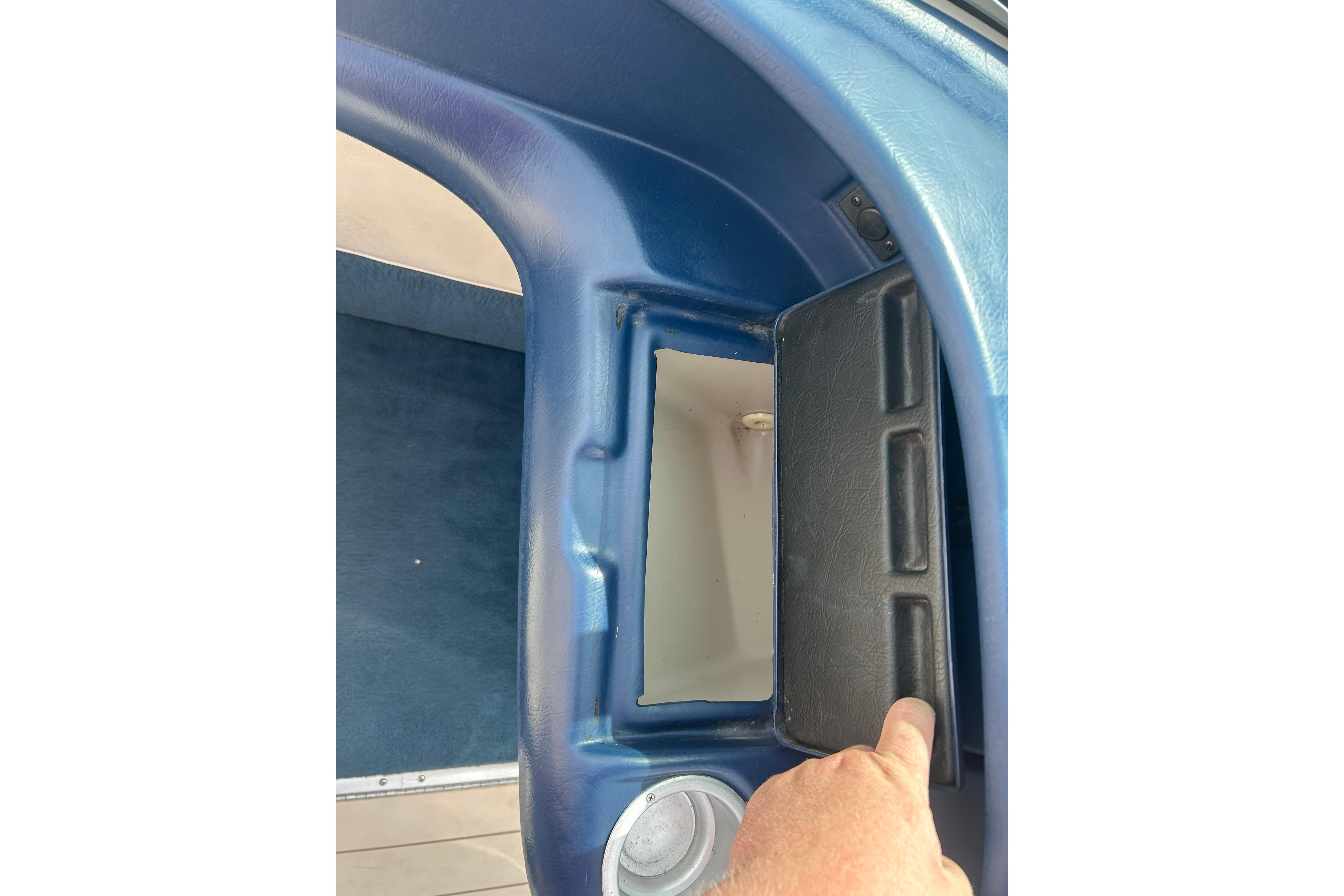Interior compartment of a 1996 Mariah 180 Shabah boat with blue and black detailing.