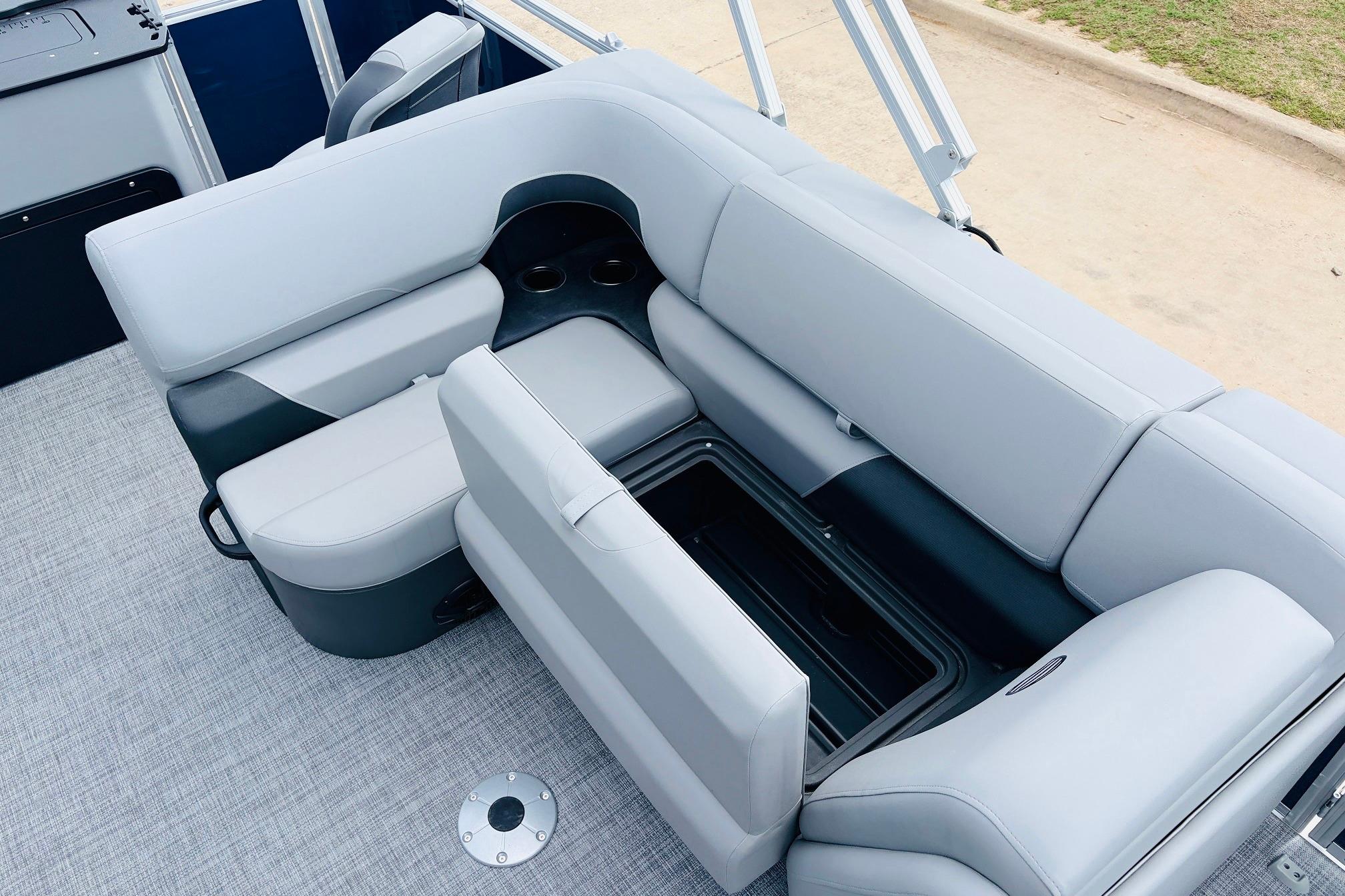 2026 Sun Tracker SportFish 22 DLX boat interior with gray seating and storage compartment.