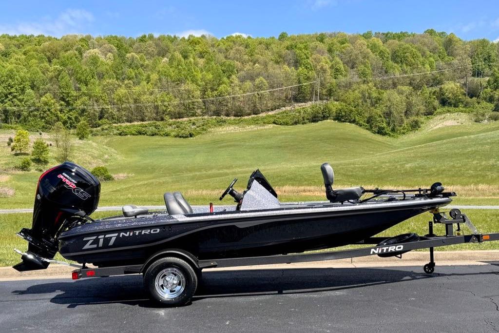 2026 Nitro Z17 boat on trailer, set against a lush green landscape.