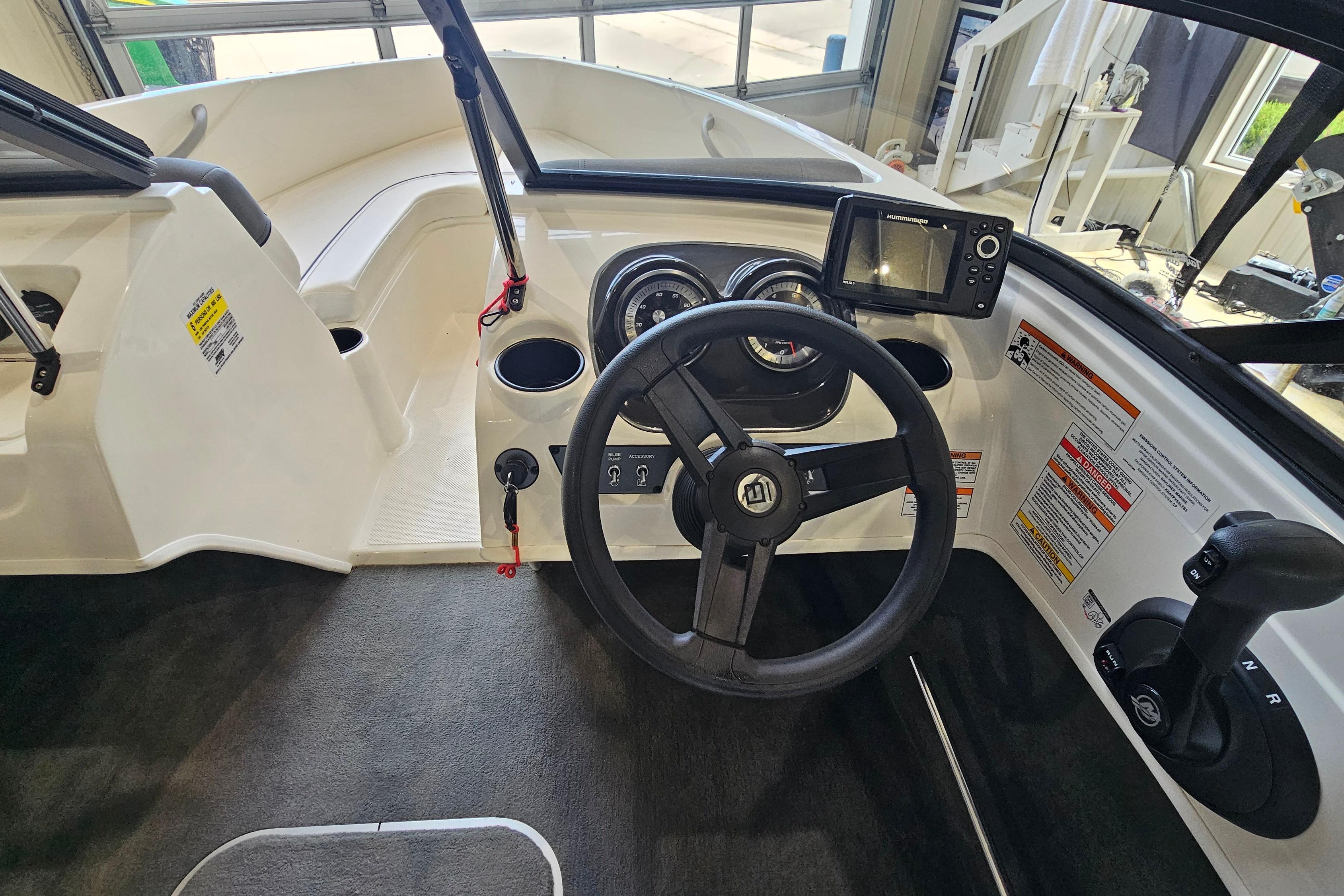 2019 Bayliner 170 Bowrider dashboard with steering wheel, gauges, and navigation system.