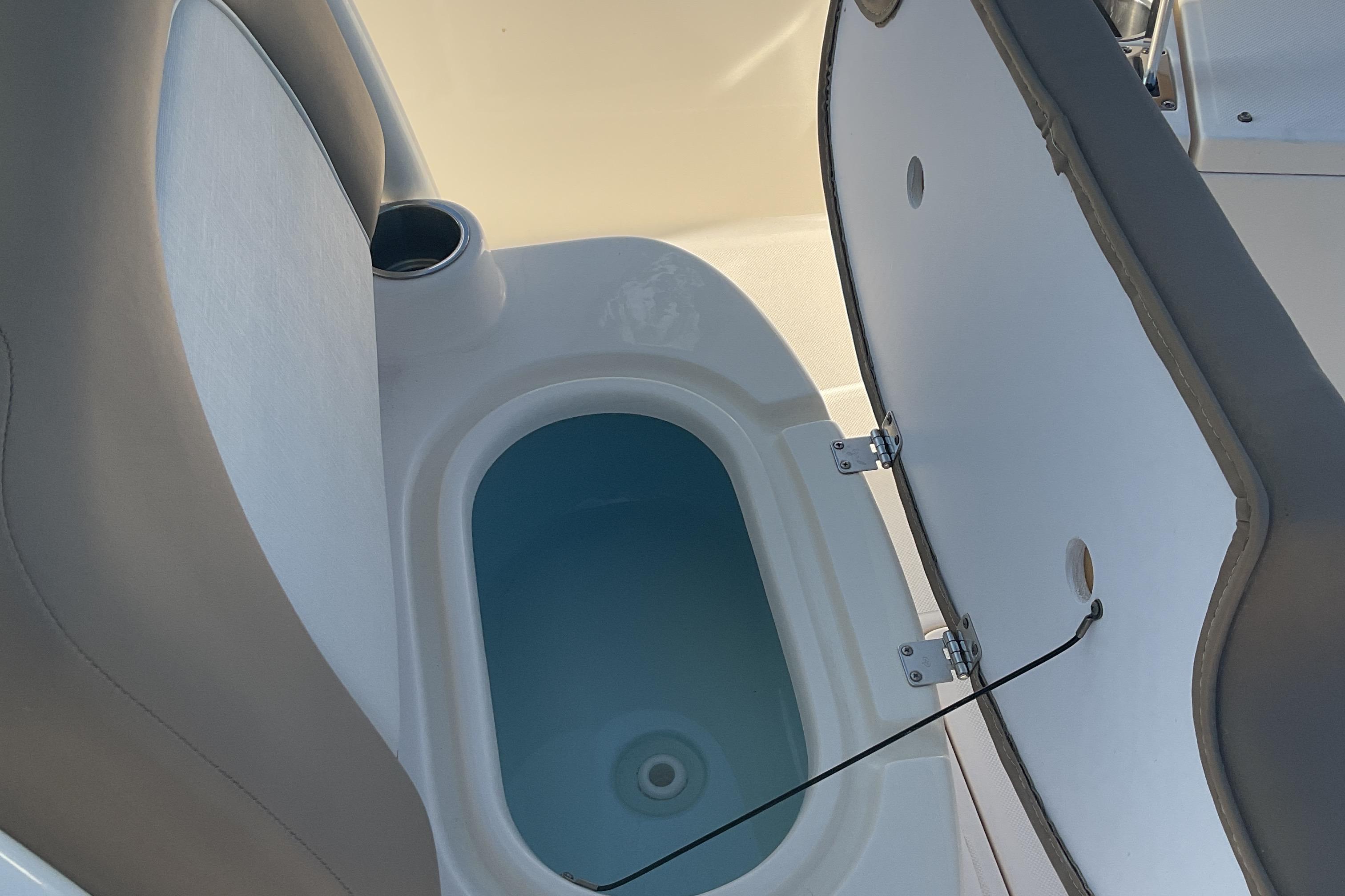 2023 Sea Born SX239 Offshore boat interior with open storage compartment.