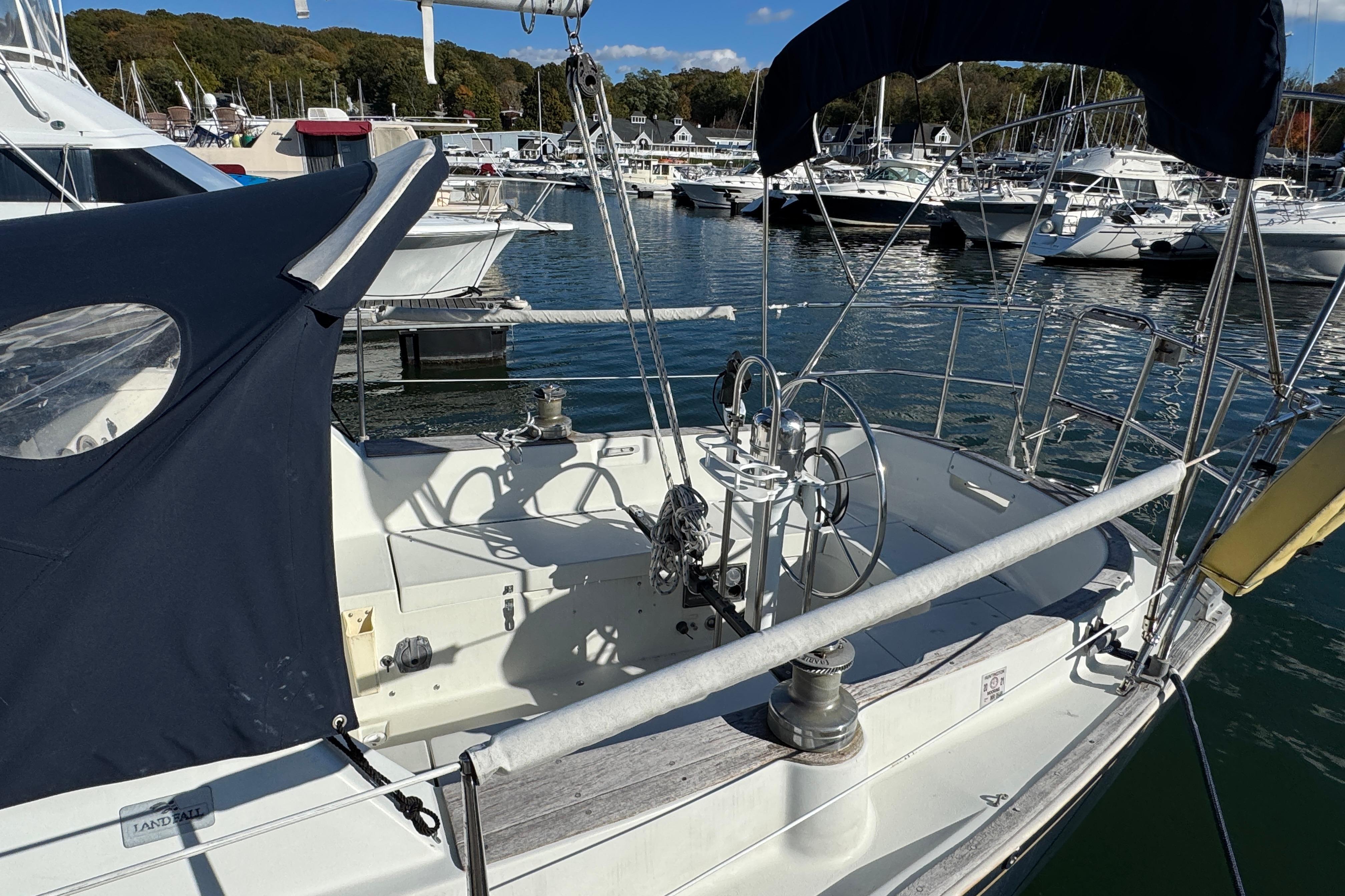 1984 C&C Landfall sailboat docked in a marina, featuring a spacious cockpit.
