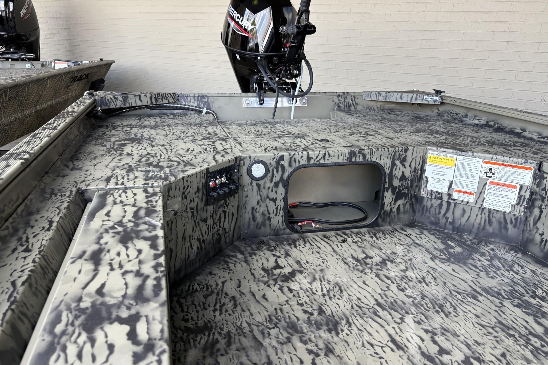 2026 Tracker Grizzly 1654 T Sportsman boat interior with camouflage design and Mercury engine.