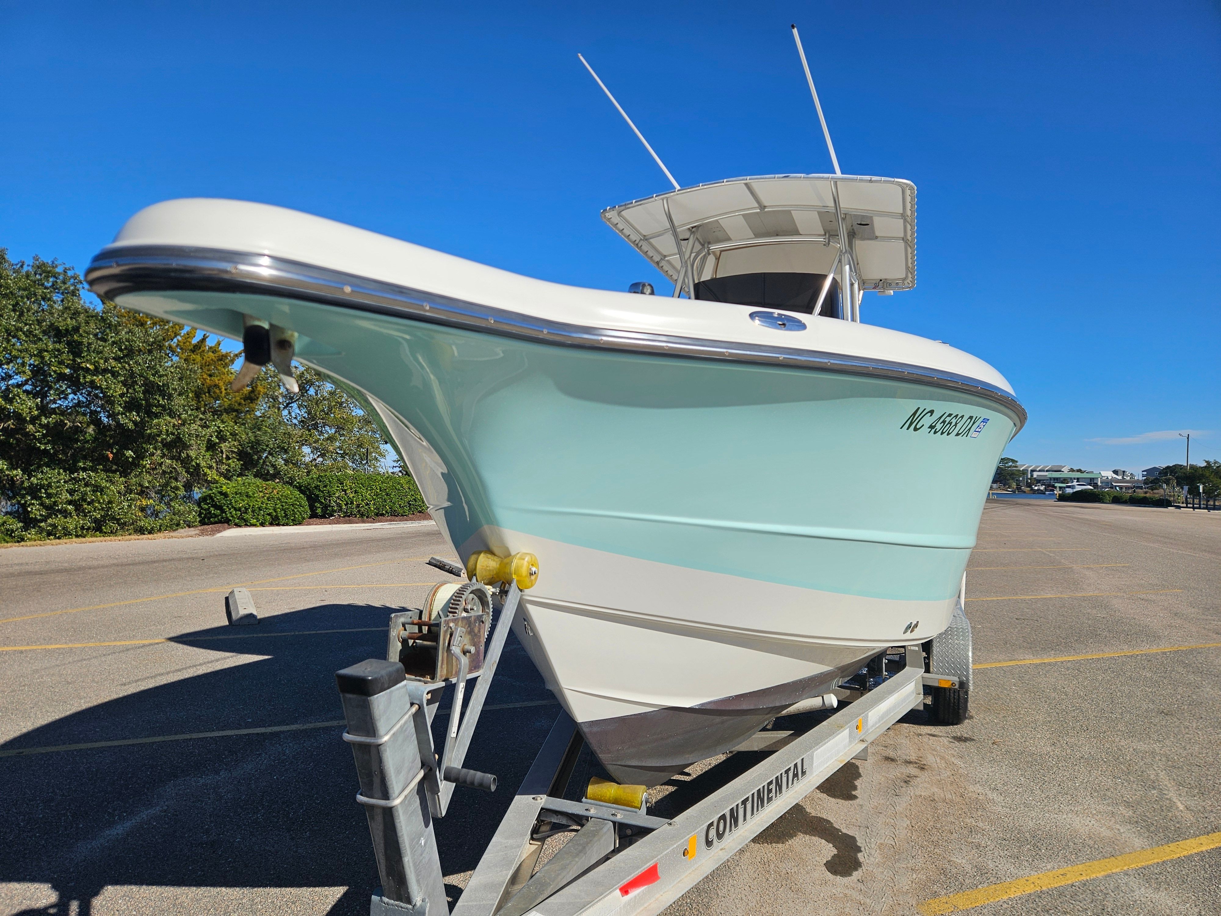 2004 Triton 2690 CC boat parked on trailer outdoors.