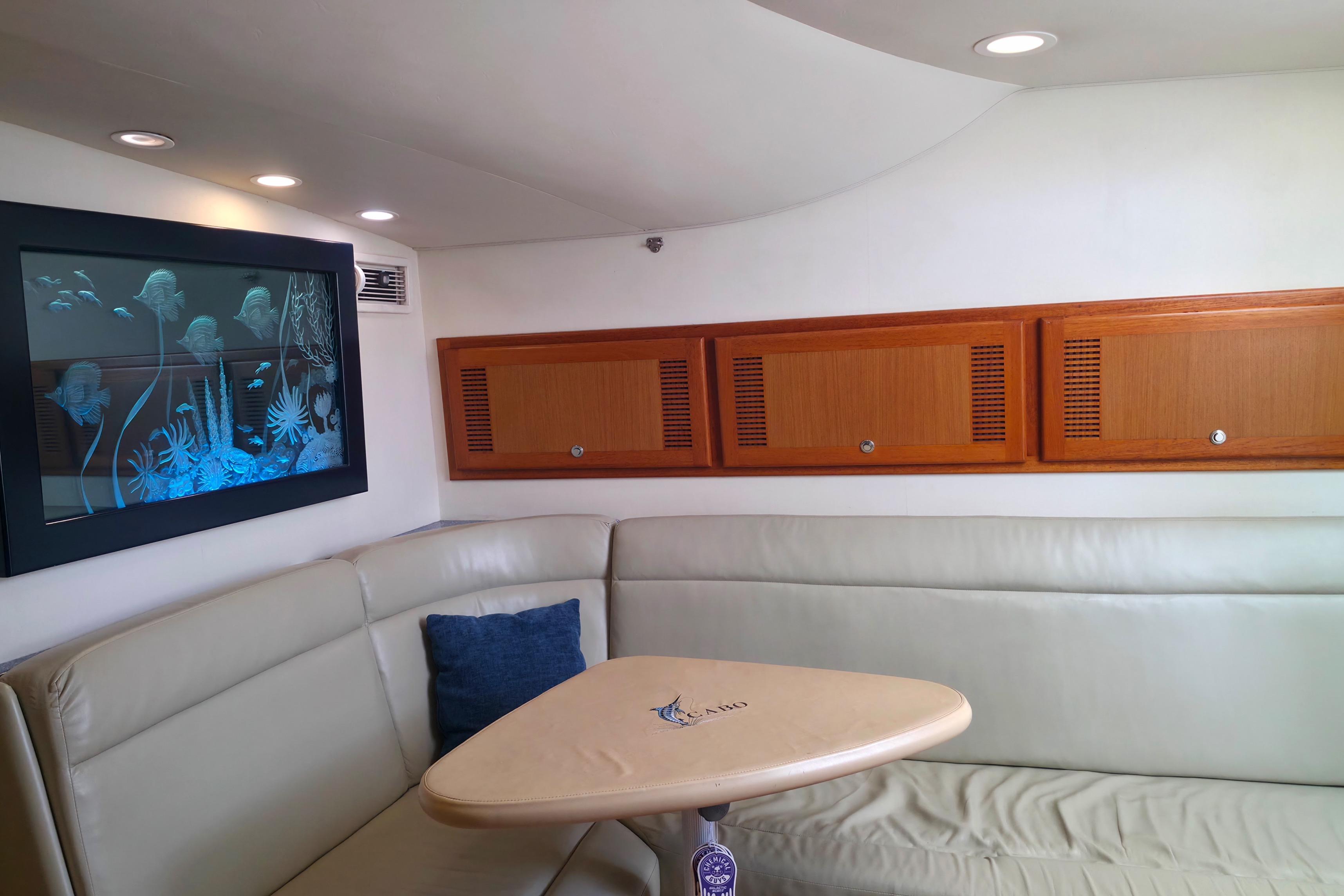 Luxurious interior of 2004 Cabo 40 Hardtop Express yacht with elegant seating and marine artwork.