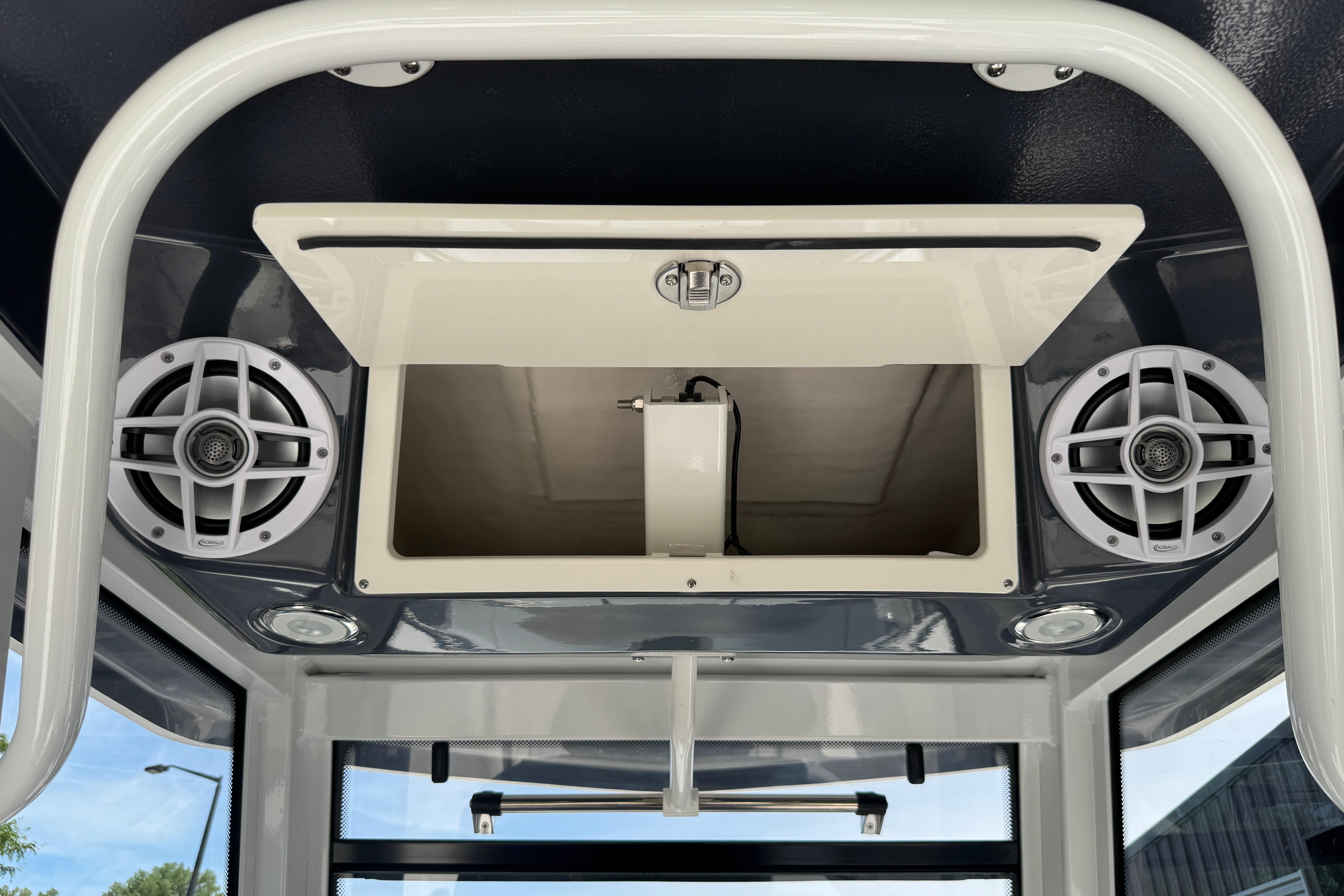 2026 Robalo R250 Center Console boat interior with speakers and storage compartment.