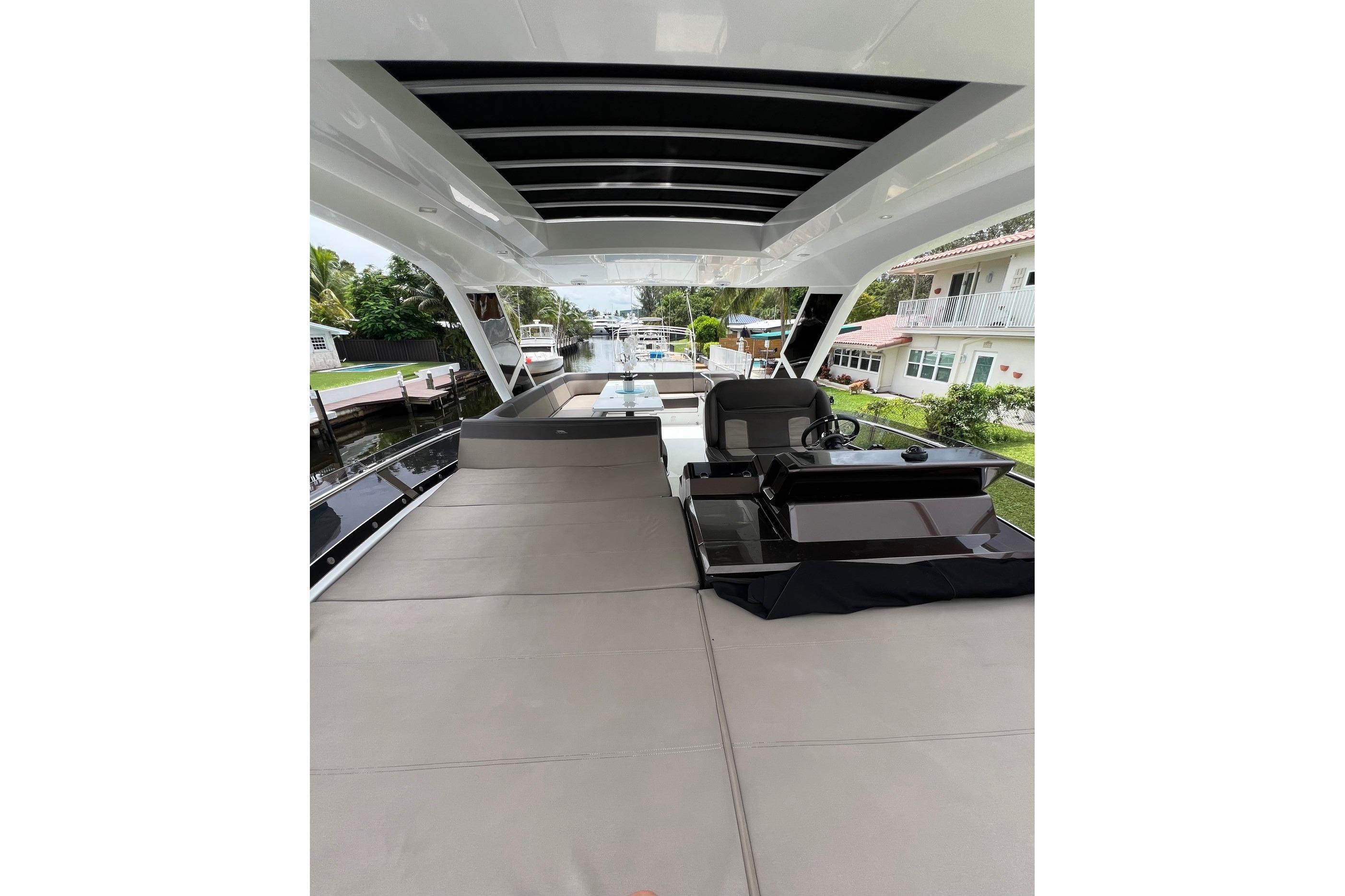 Flybridge view of 2020 Galeon 550 Fly yacht, featuring spacious seating and helm station.