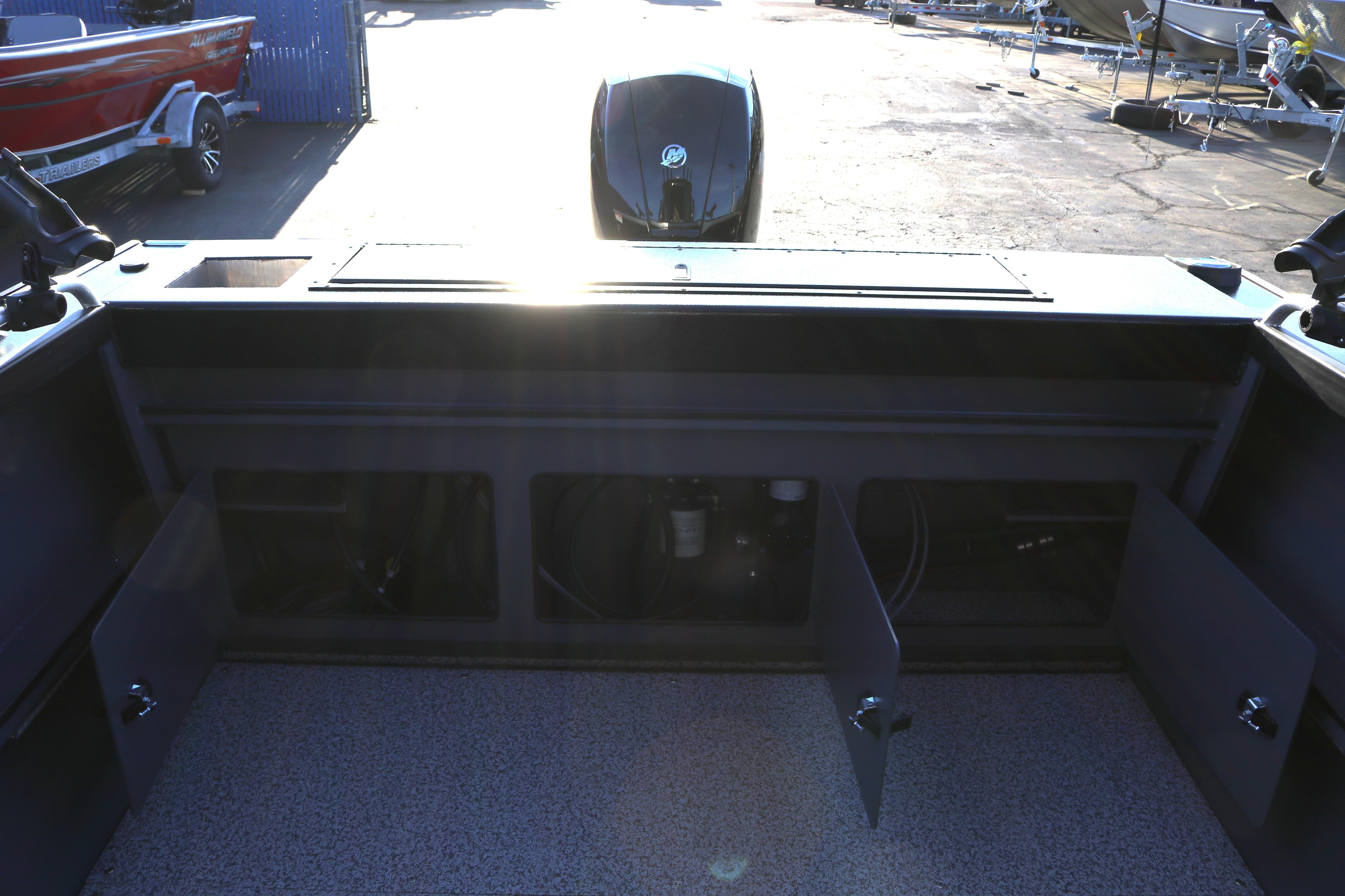 2026 Alumaweld Stryker X202 boat interior with open storage compartments and visible engine.