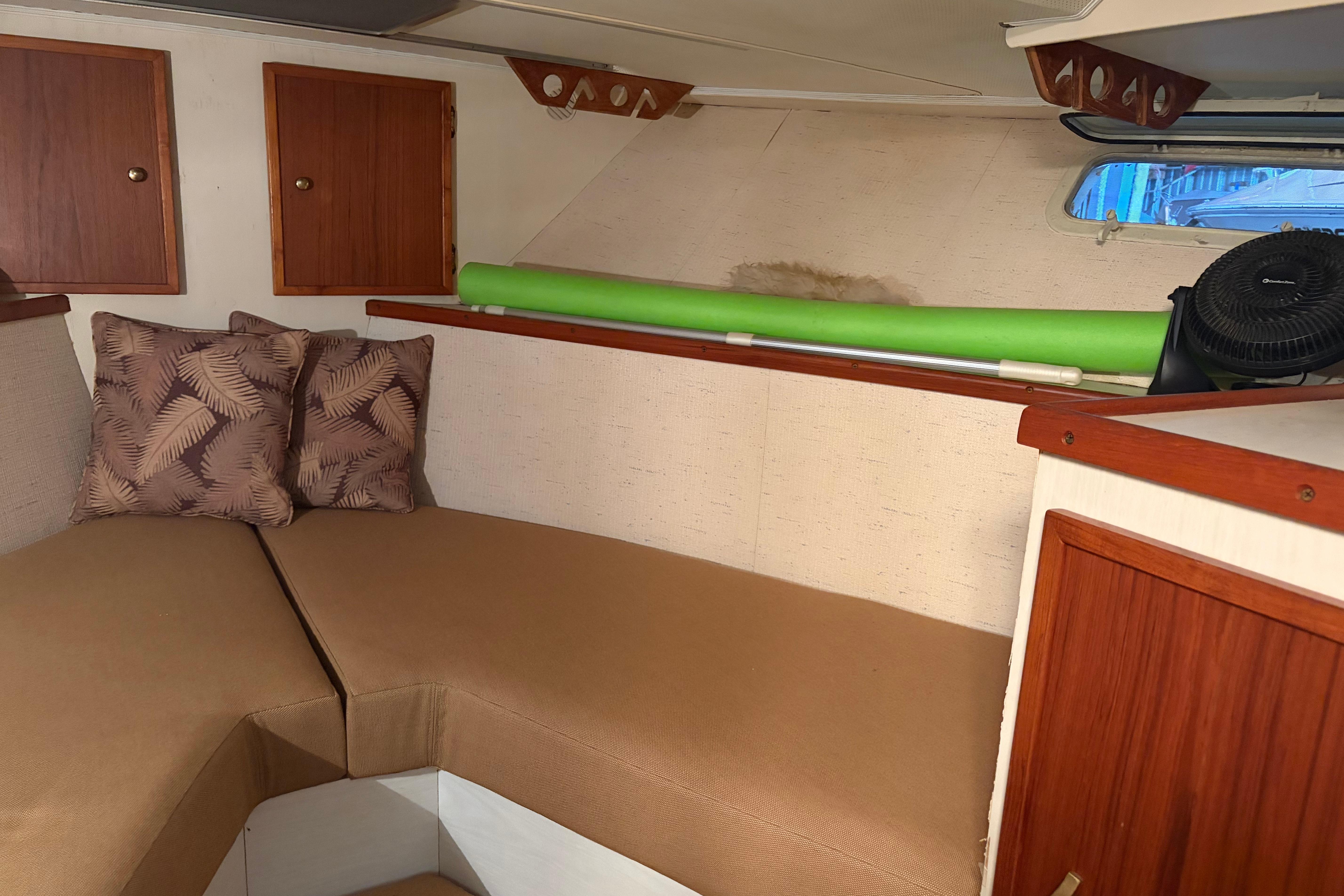 Interior of 1971 Chris-Craft 42 Commander boat with cushions and wooden cabinets.