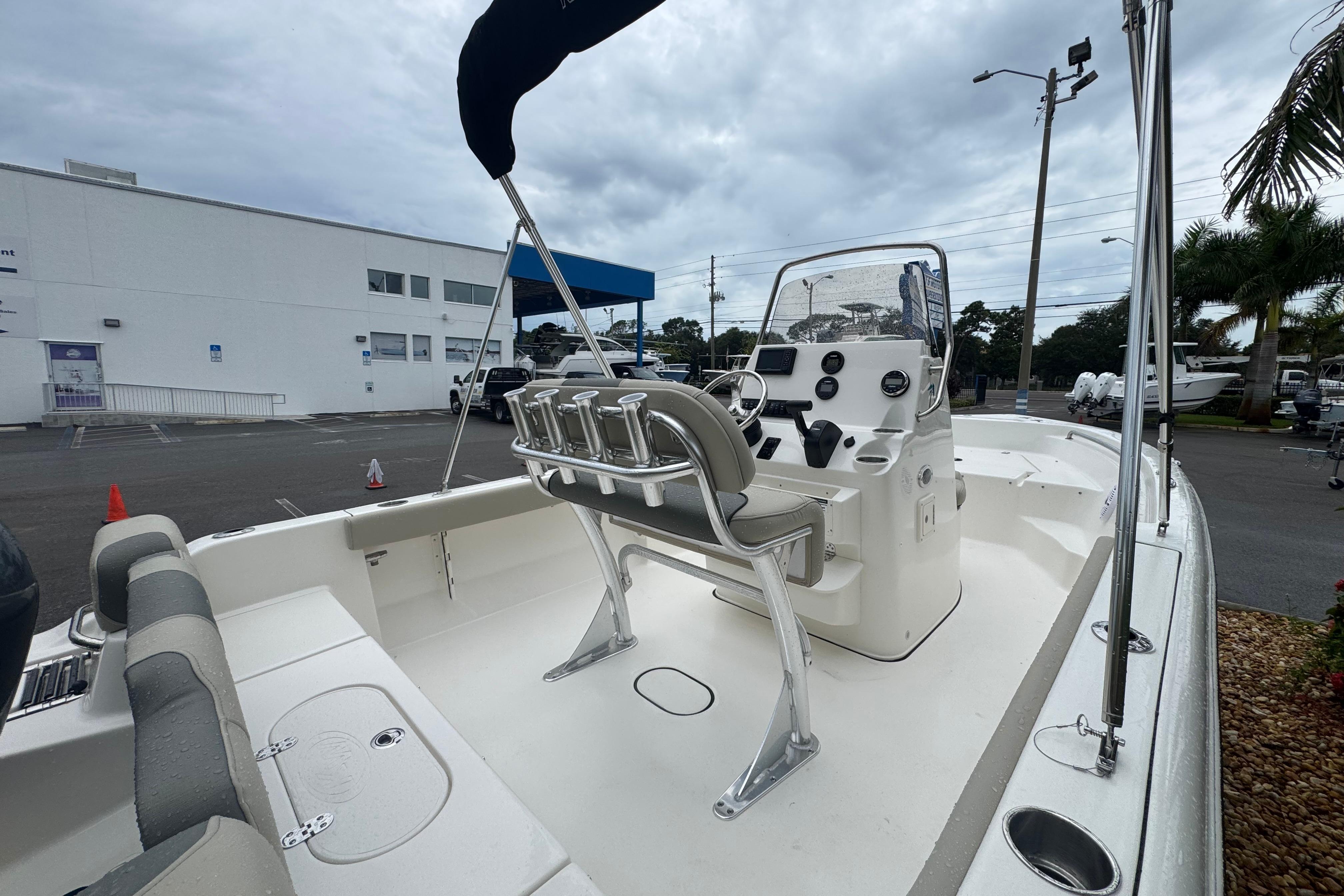2026 Key West 189 FS boat interior with console and seating, parked outdoors.