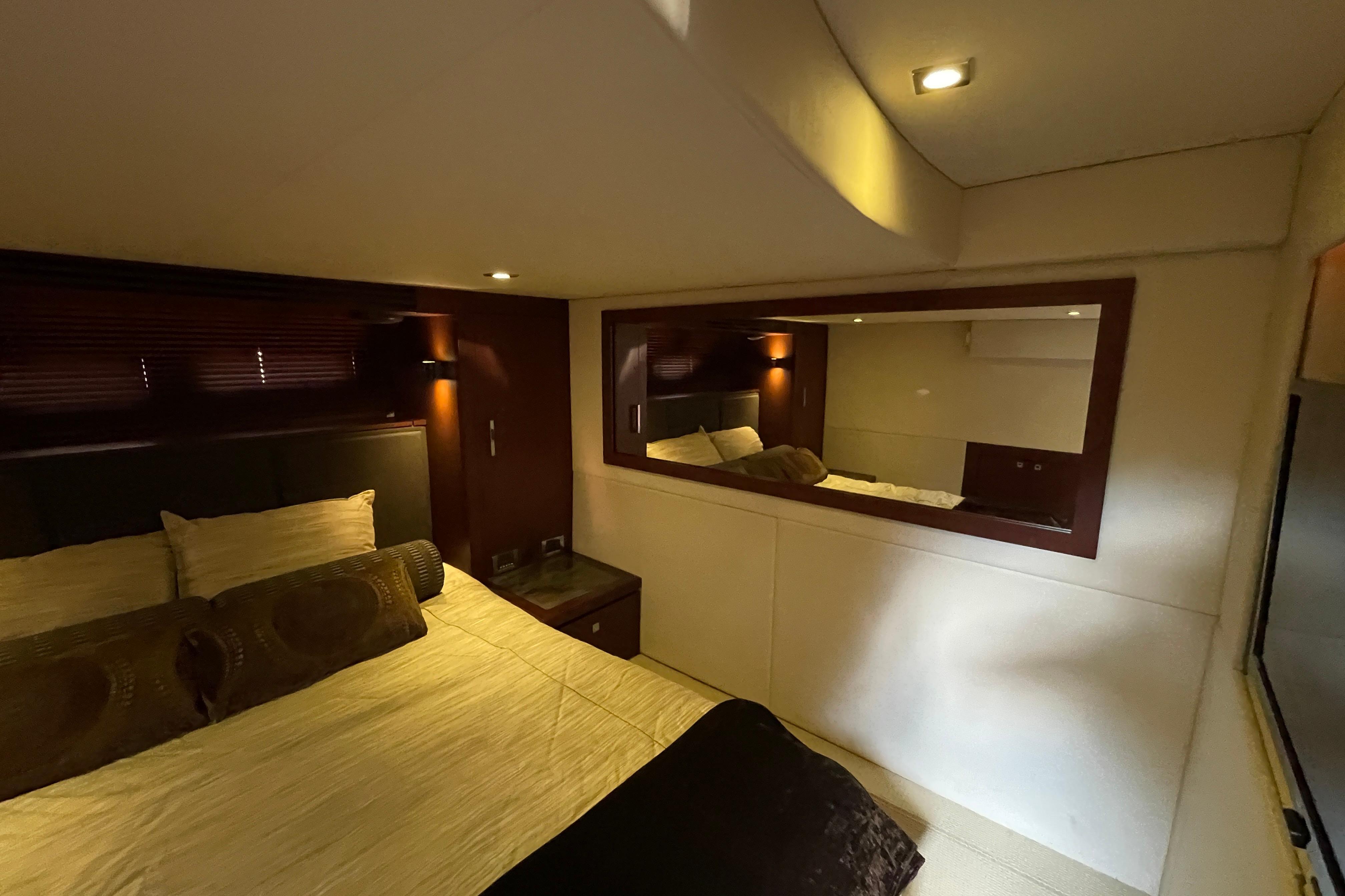 Luxurious bedroom interior of 2013 Sea Ray 510 Sundancer yacht with elegant lighting.