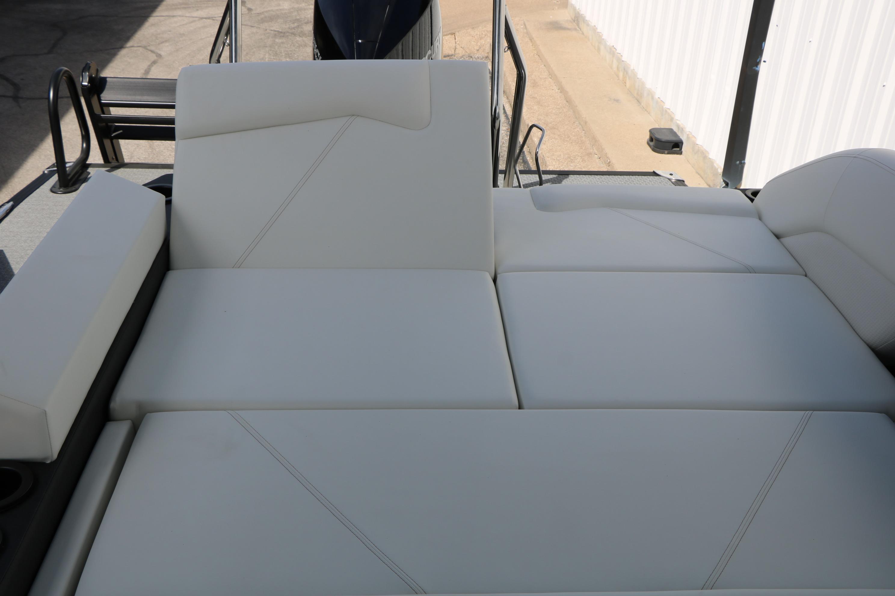 Luxurious seating on 2026 Evotti 725 CS Tri-Toon boat, featuring sleek white upholstery.