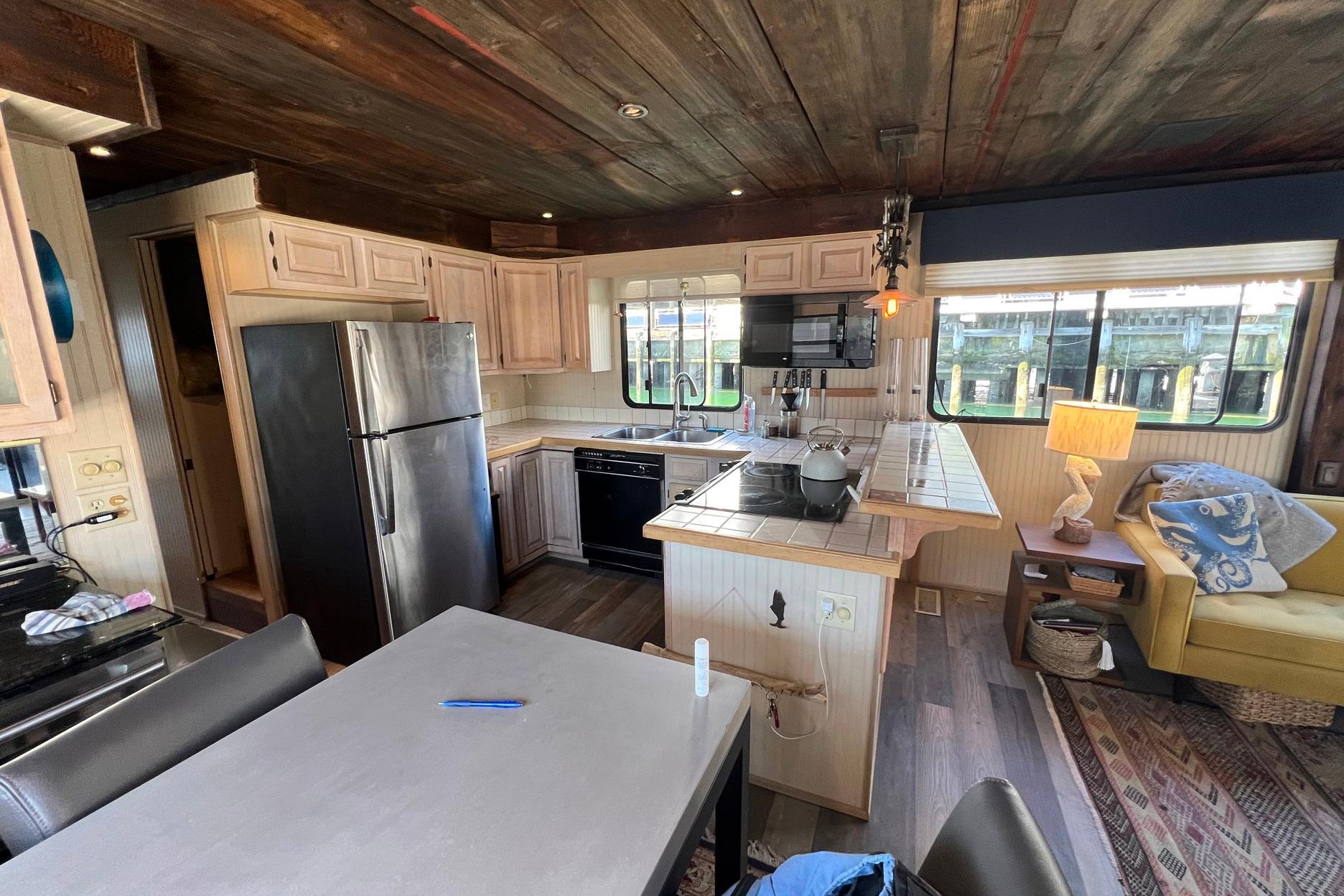 Interior of a 1993 Sumerset houseboat featuring a kitchen and cozy living area.