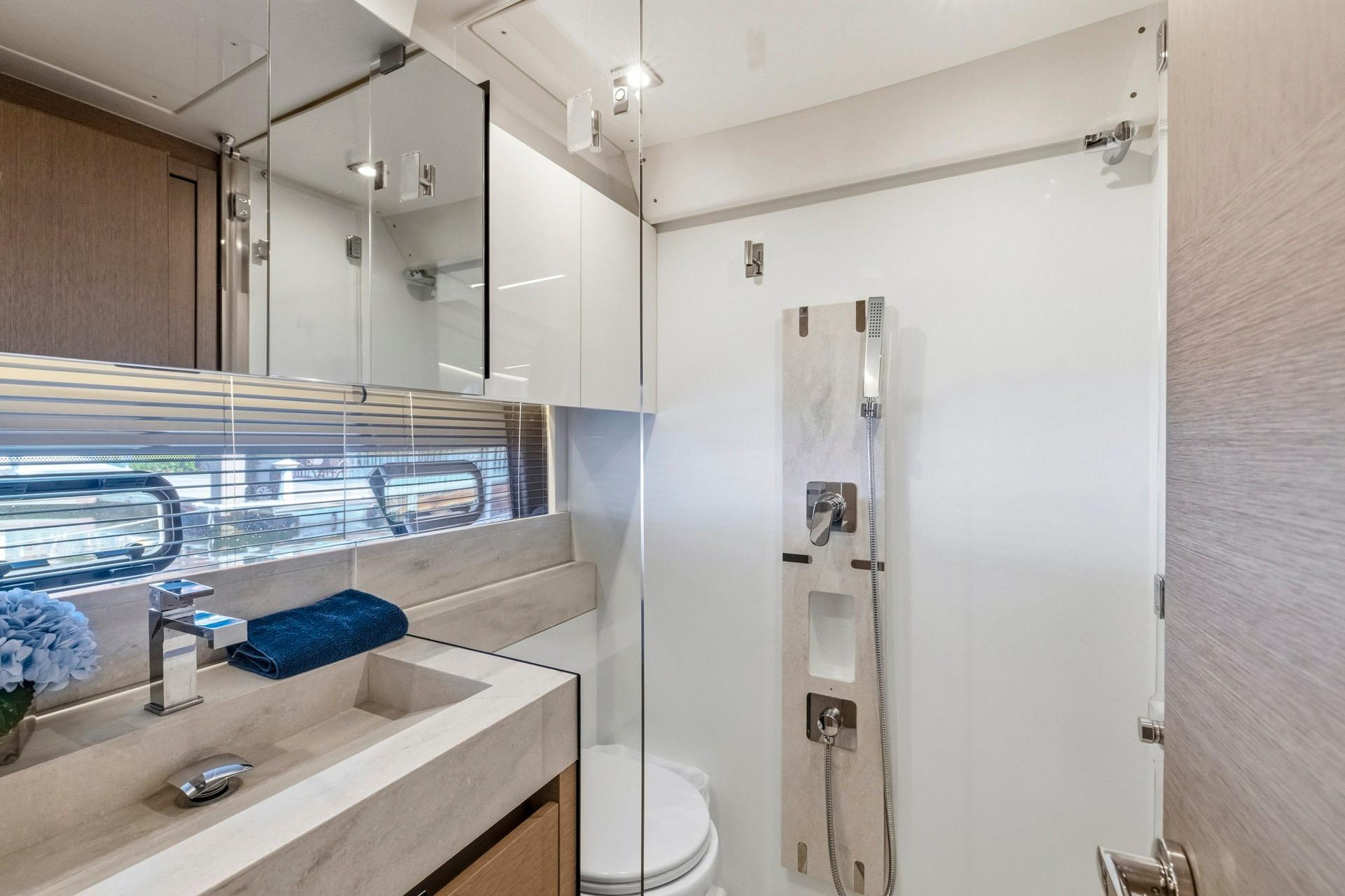 Luxurious bathroom interior of 2022 Prestige 520 yacht with modern fixtures and elegant design.
