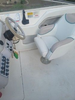 Interior of a 1996 Wellcraft 2400S boat with steering wheel and seat.
