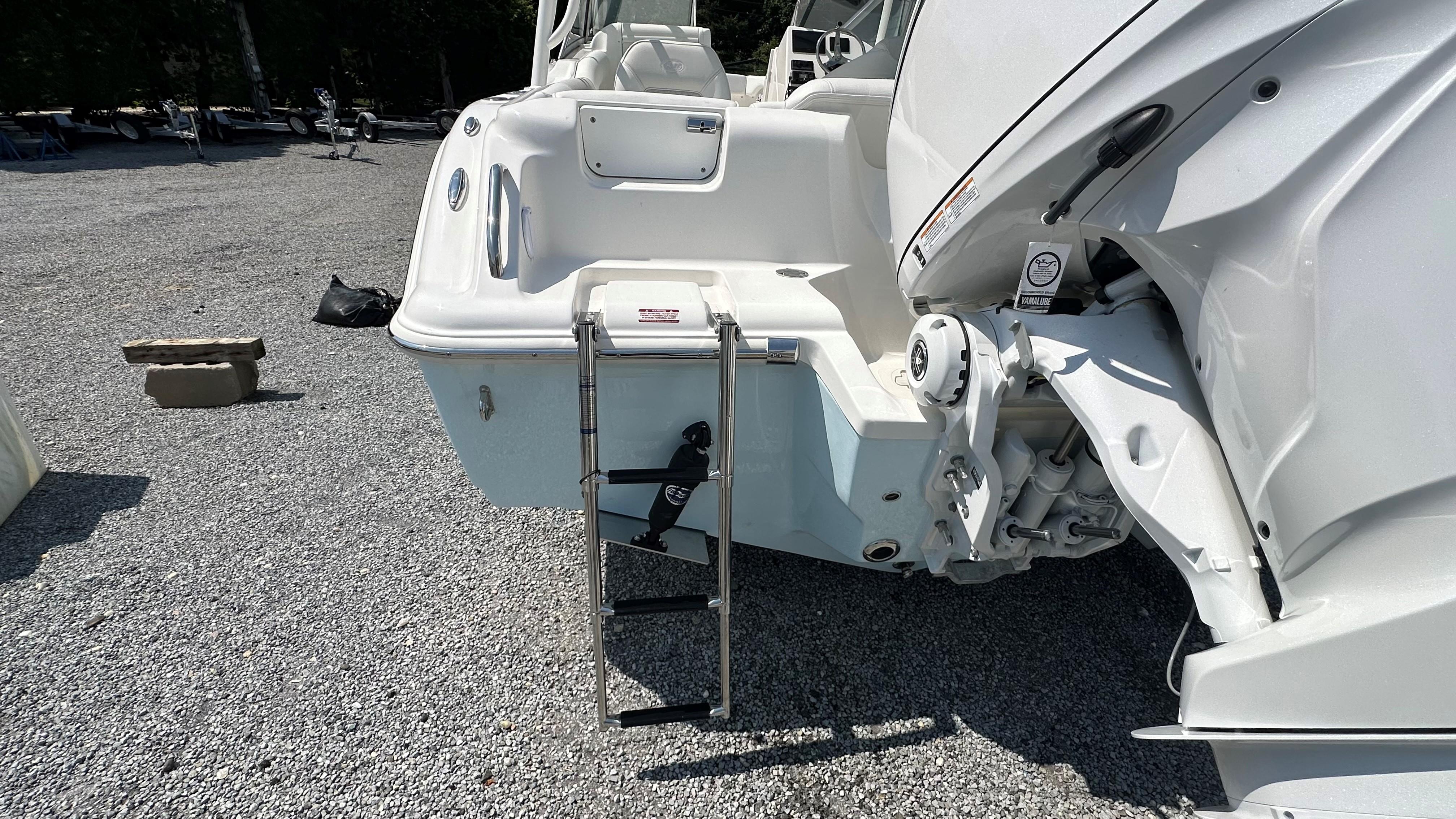 2026 Key West 239 DFS boat with ladder on gravel surface.