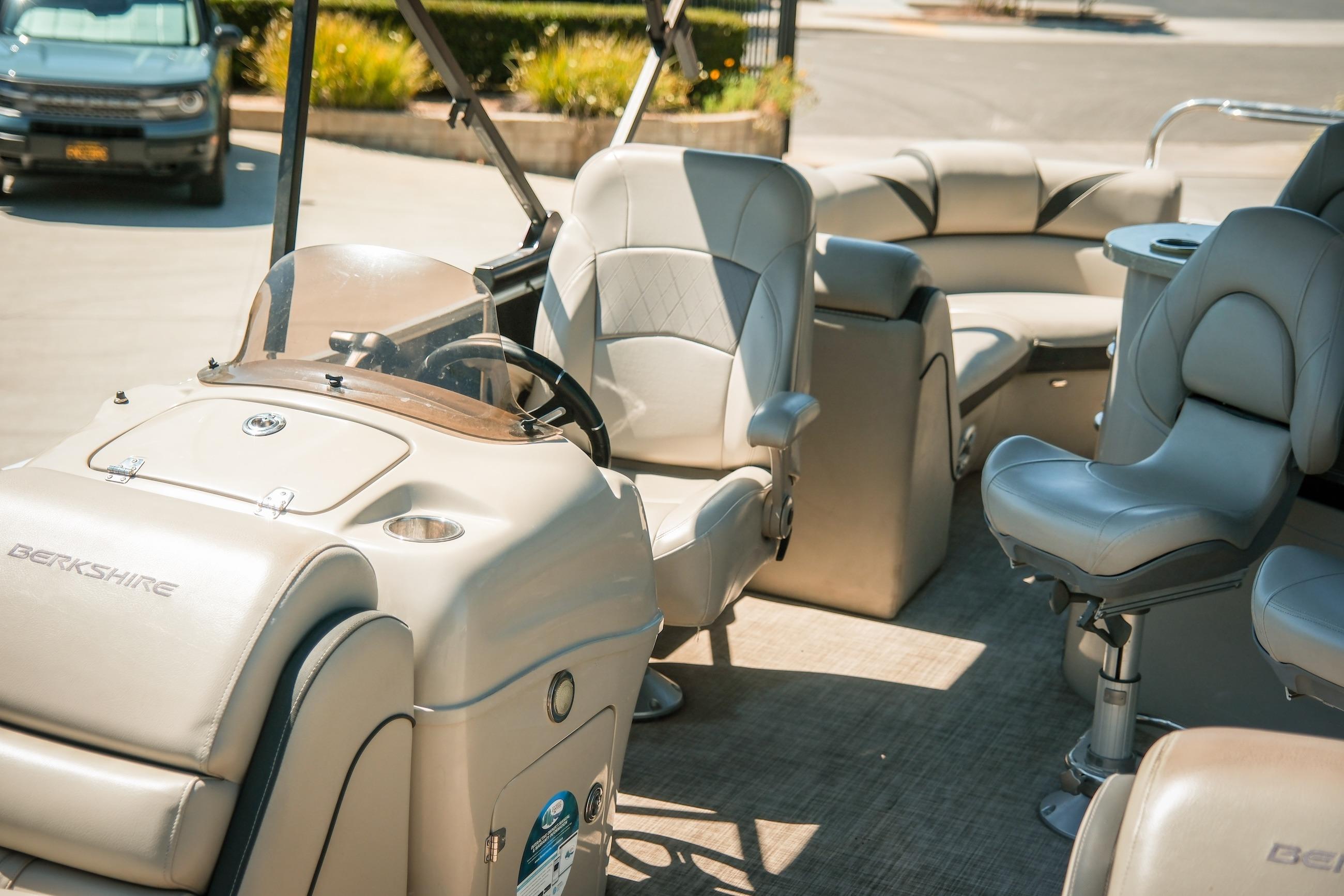 2019 Berkshire 25CLE STS pontoon boat interior with plush seating and steering console.
