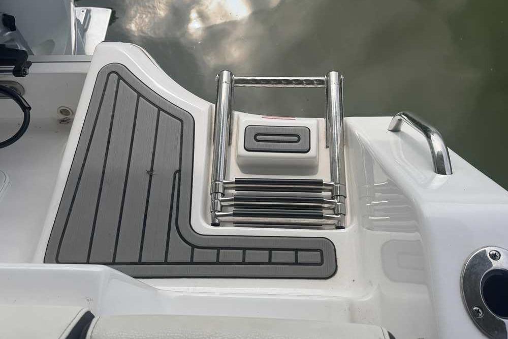 2024 Tidewater 232 LXF boat swim platform with retractable ladder and non-slip surface.