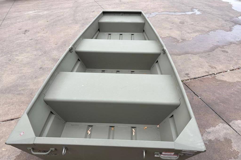 2026 Tracker Grizzly 10 Jon boat on concrete surface, showcasing interior seating.