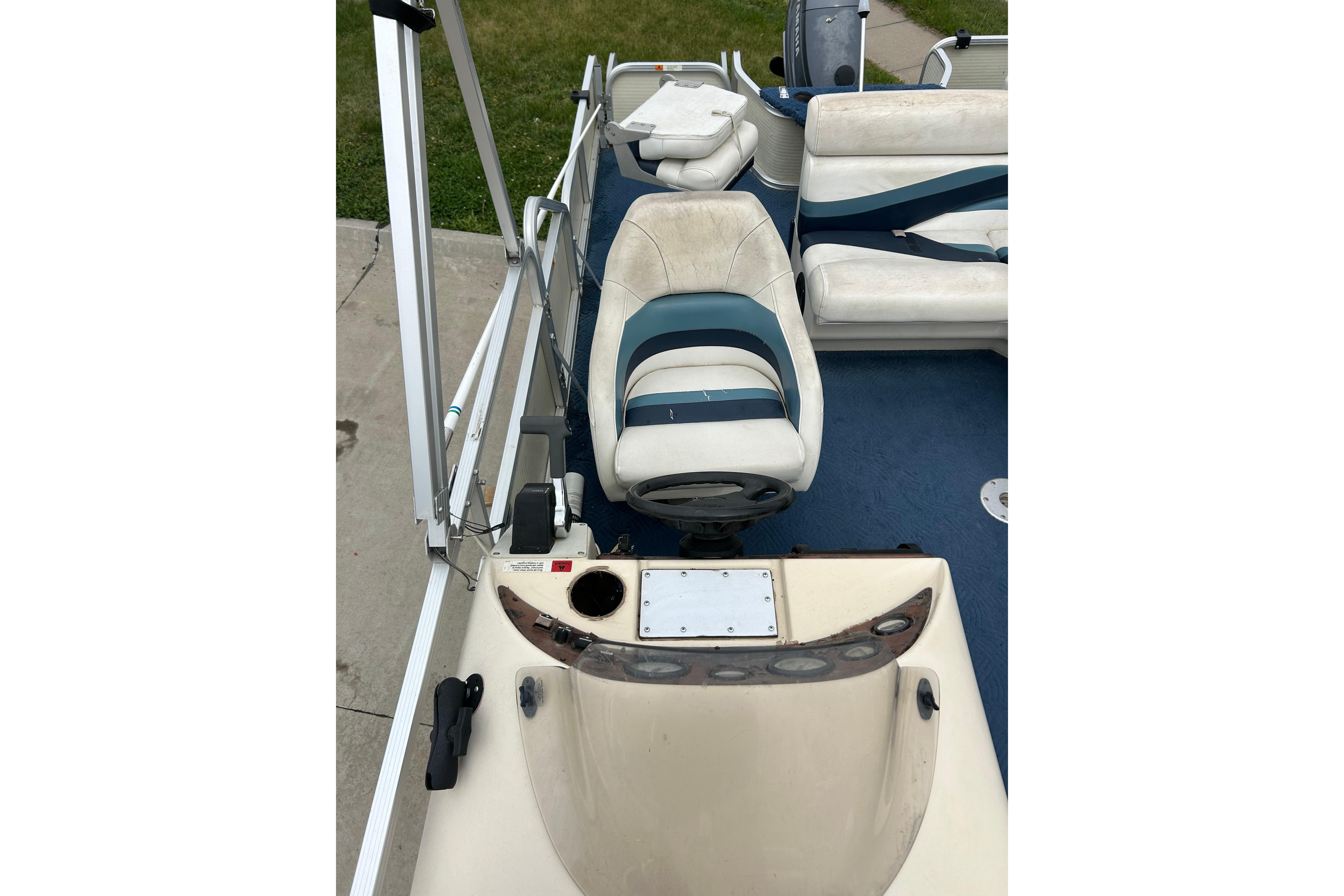 2002 Lowe Trinidad 200 boat interior with seating and steering console.