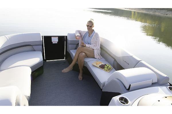 Manufacturer Provided Image: Woman relaxing on 2025 Lowe SS 230 WV boat with snacks and drink.
