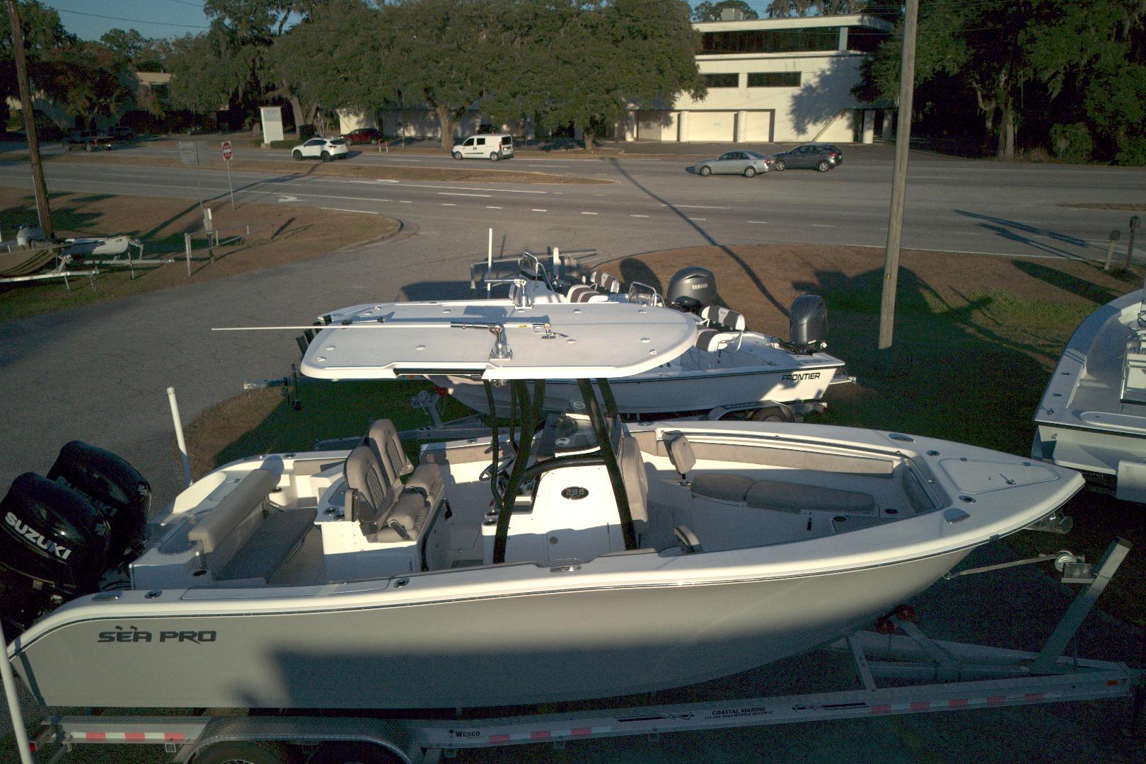 2021 Sea Pro 259 Center Console boat on trailer, parked outdoors.