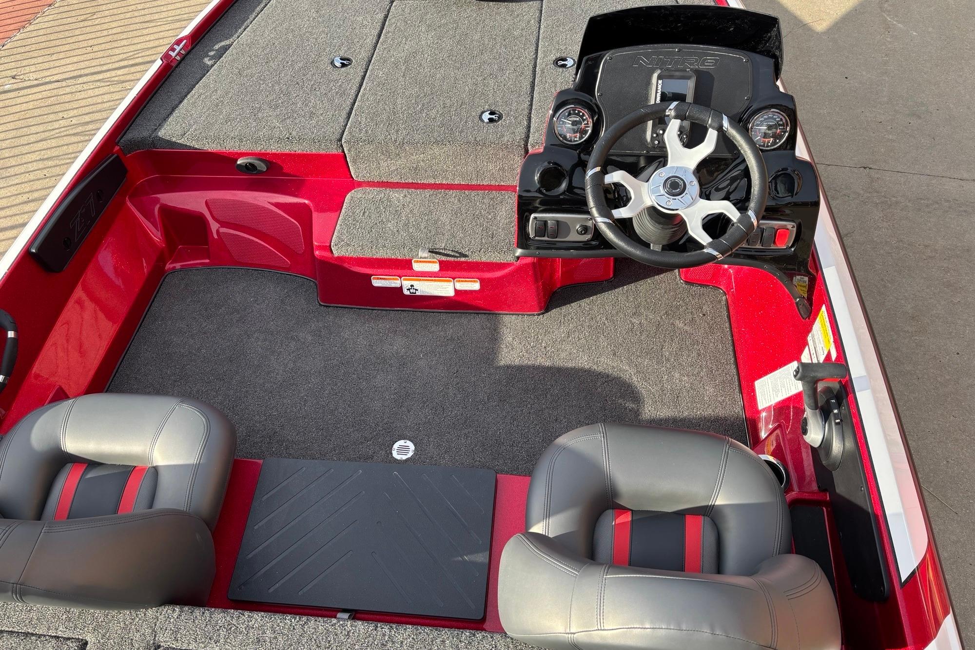 Red 2026 Nitro Z17 boat interior with steering wheel and two seats.
