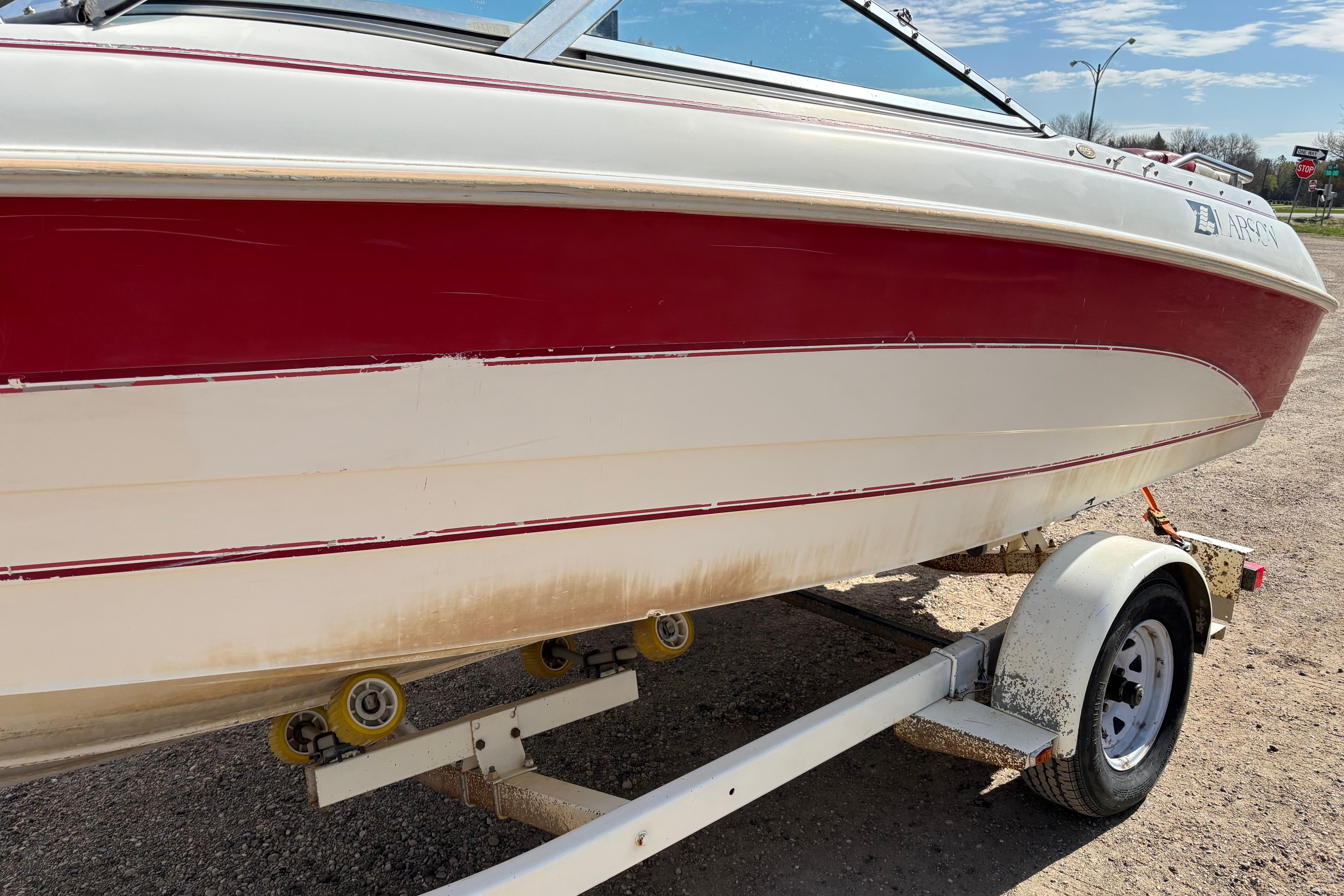 1993 Larson SEi 200 Cuddy I/O boat on trailer, red and white exterior.