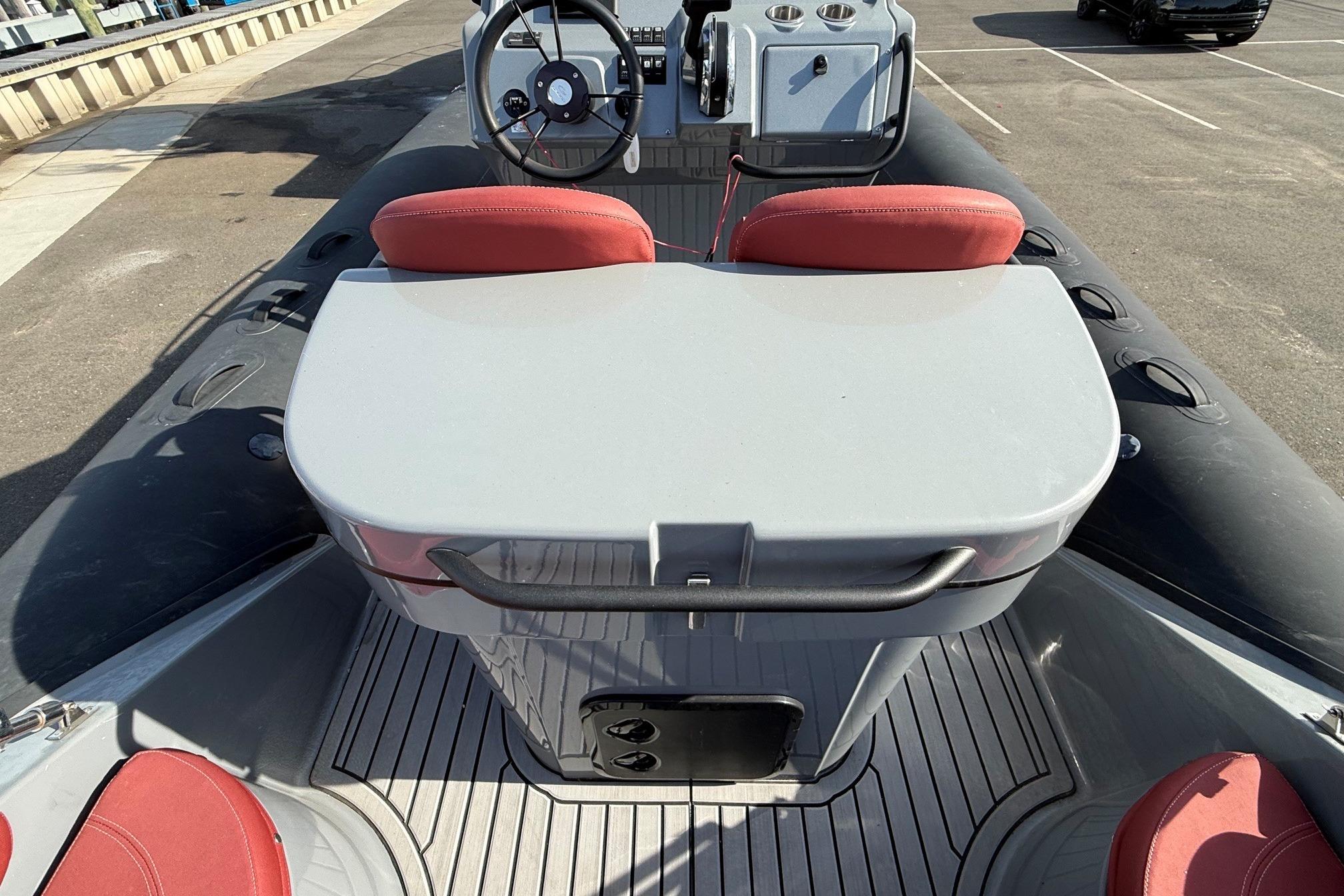 2023 Grand Inflatables Gold 850 boat interior with red seating and steering console.