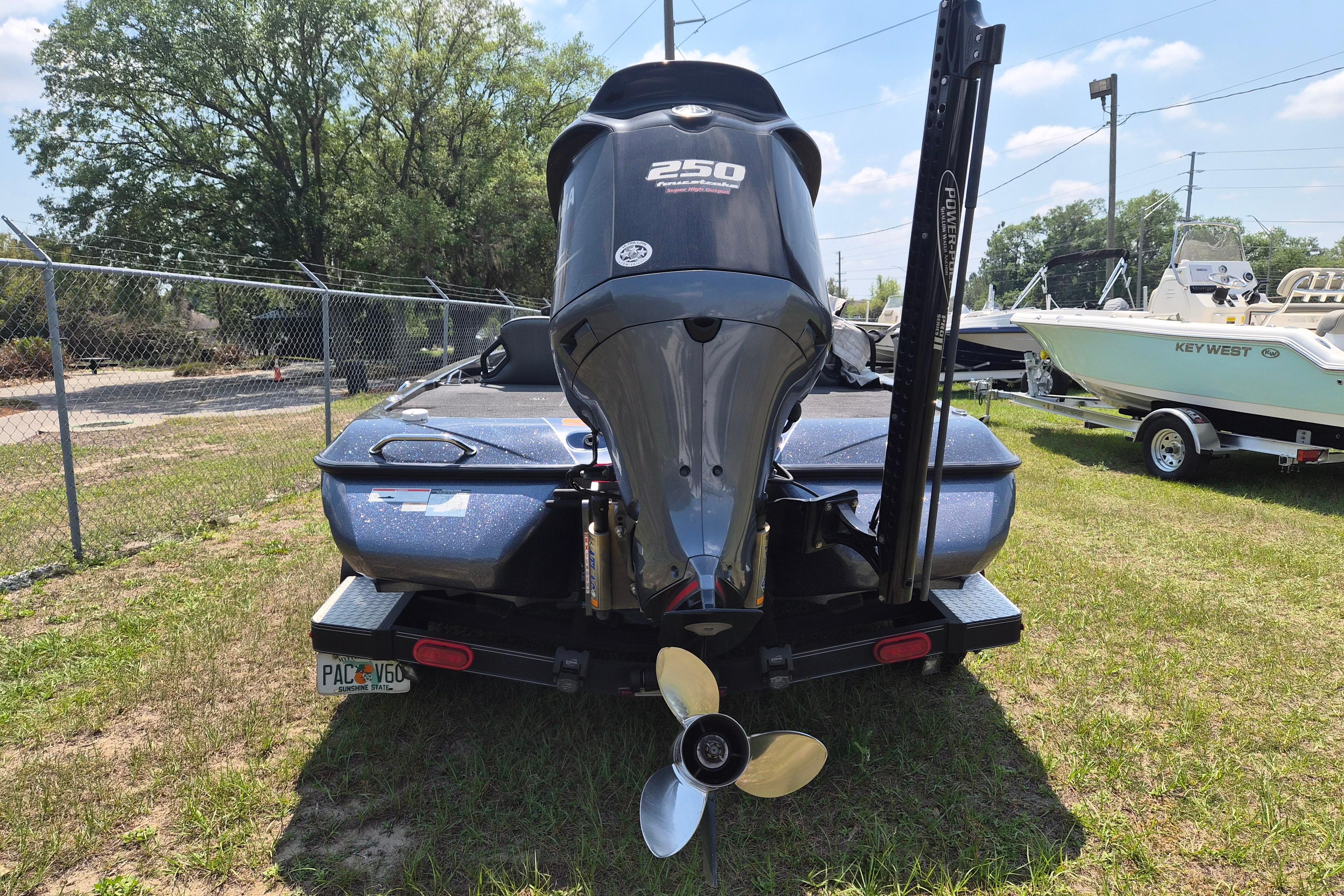 2021 Skeeter ZXR20 boat with powerful outboard motor, parked on grass.