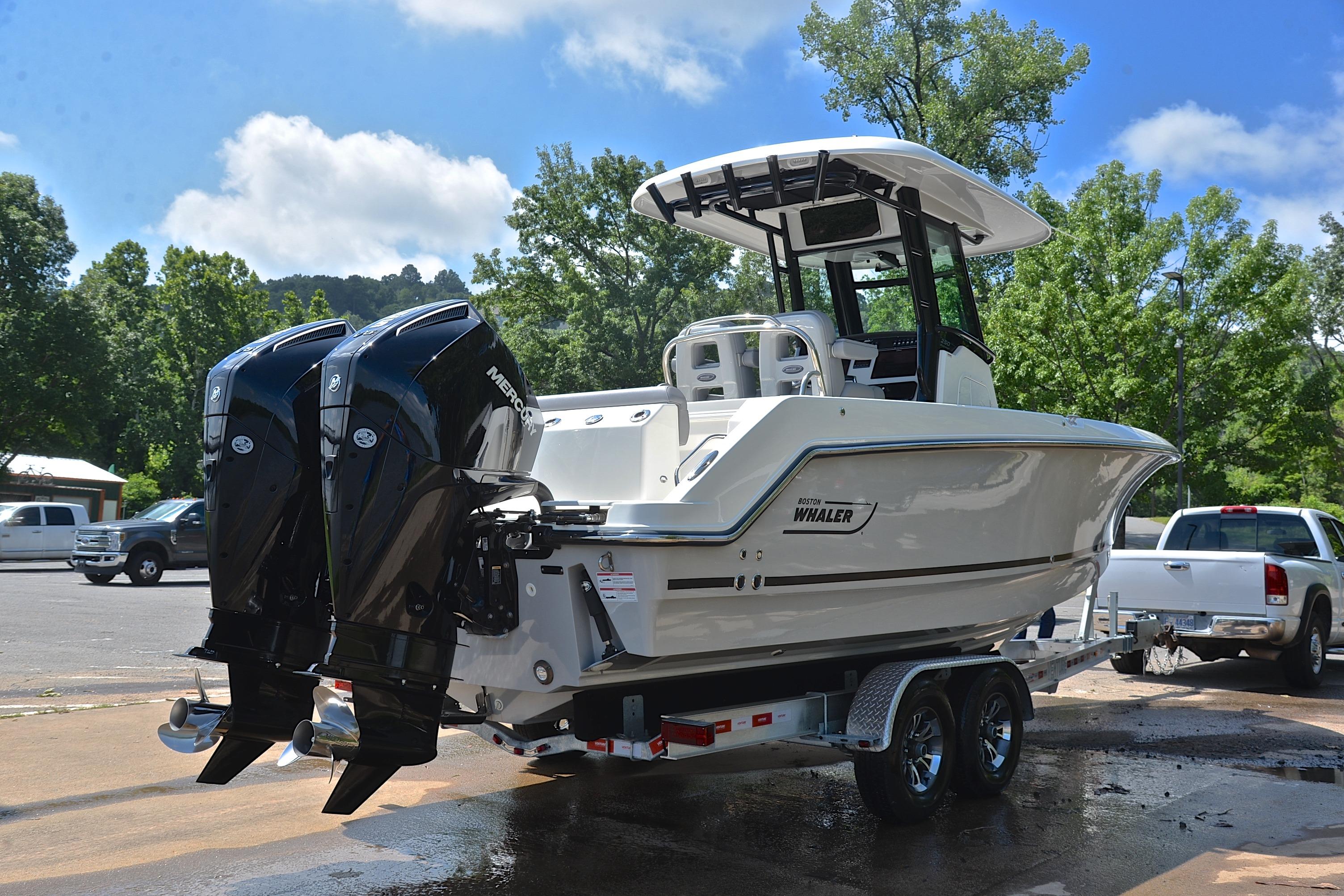 2024 Boston Whaler 250 Outrage boat on trailer with dual Mercury engines.