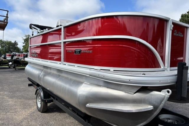 2026 Sun Tracker Party Barge 16 DLX pontoon boat with red exterior on a trailer.