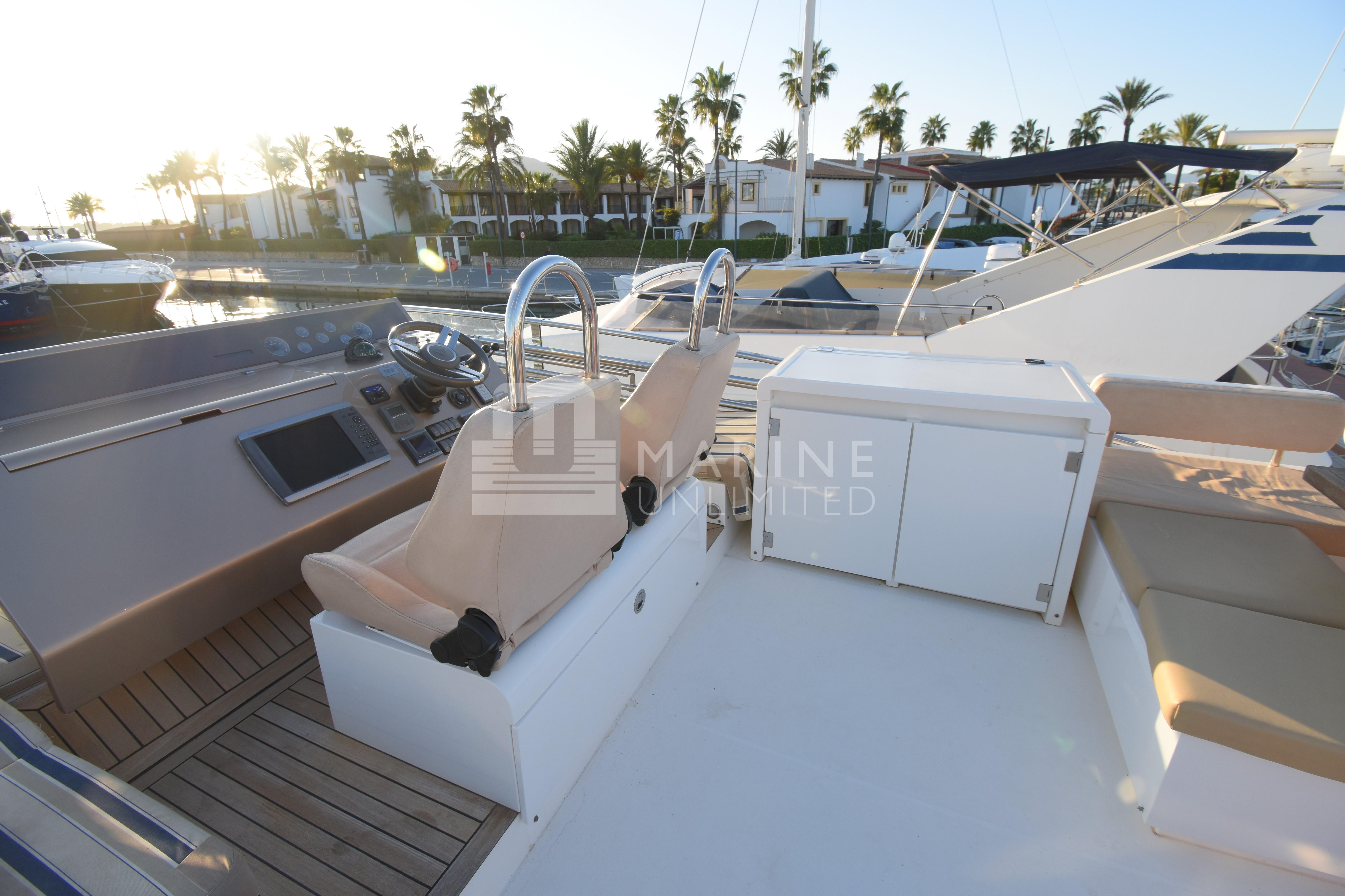 Luxurious 2010 Fairline Squadron 55 yacht interior with helm and seating area.
