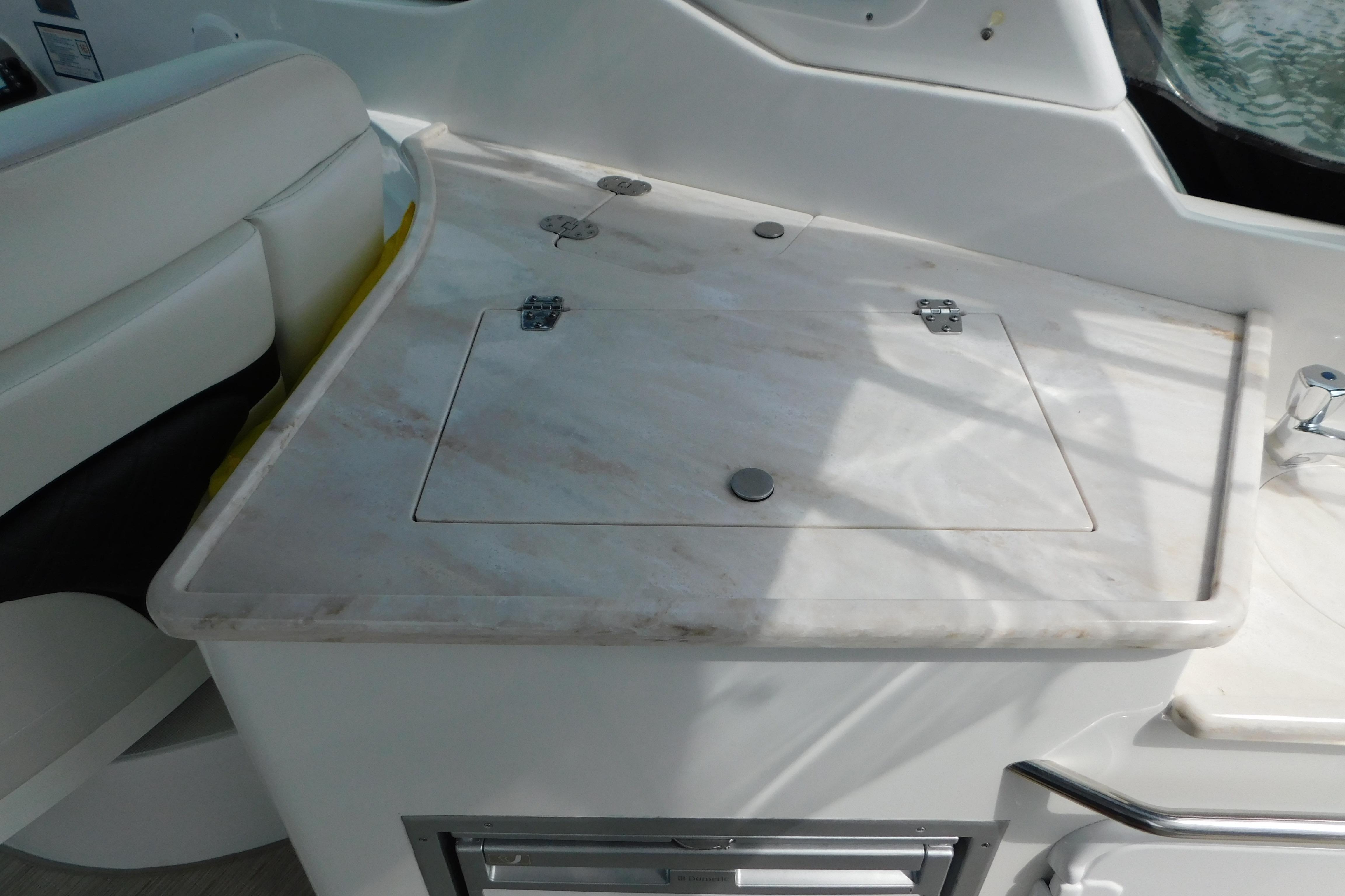 2017 Rinker EX 320 boat interior with white countertop and seating area.