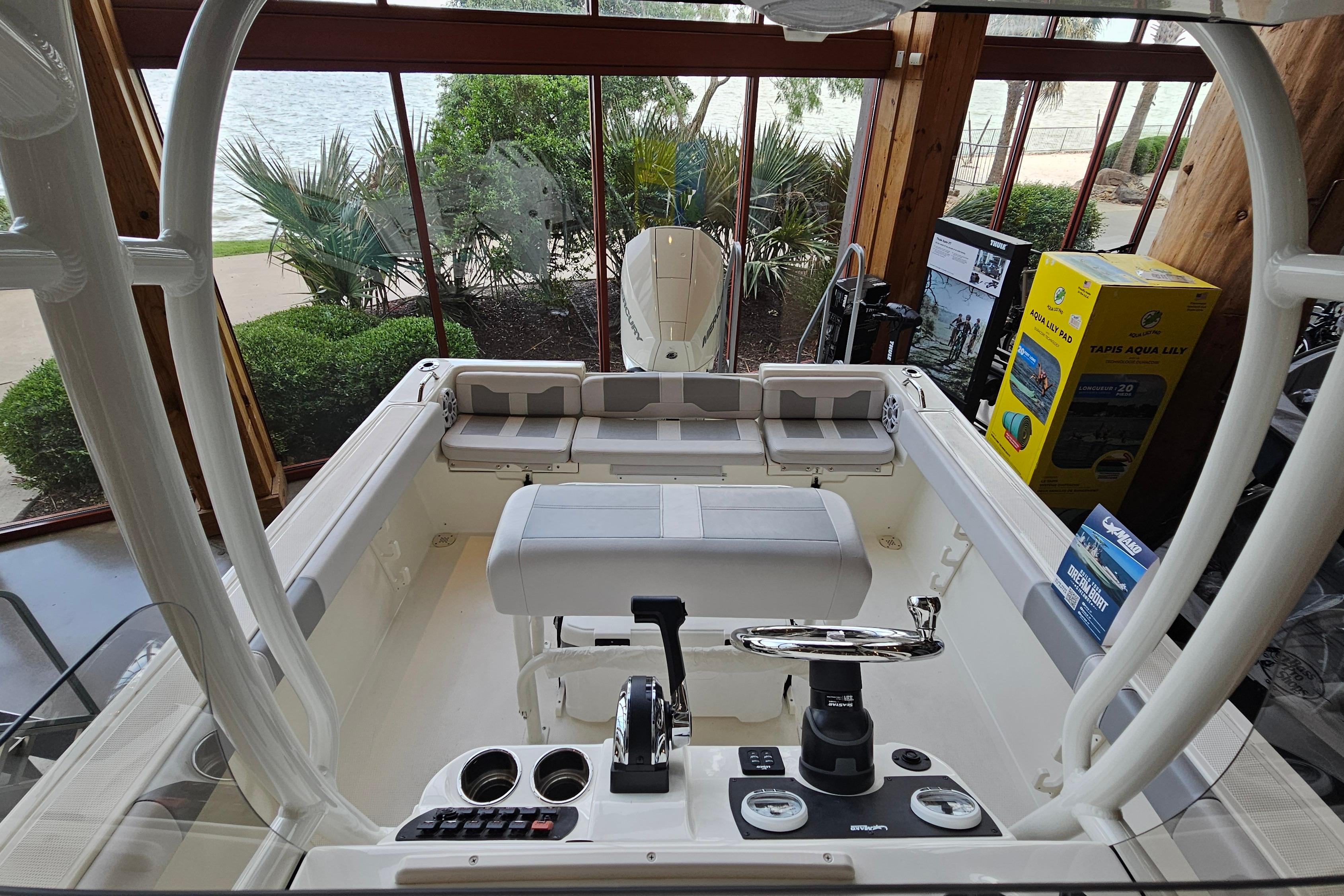 2025 Mako 214 Center Console boat interior with seating and control panel.