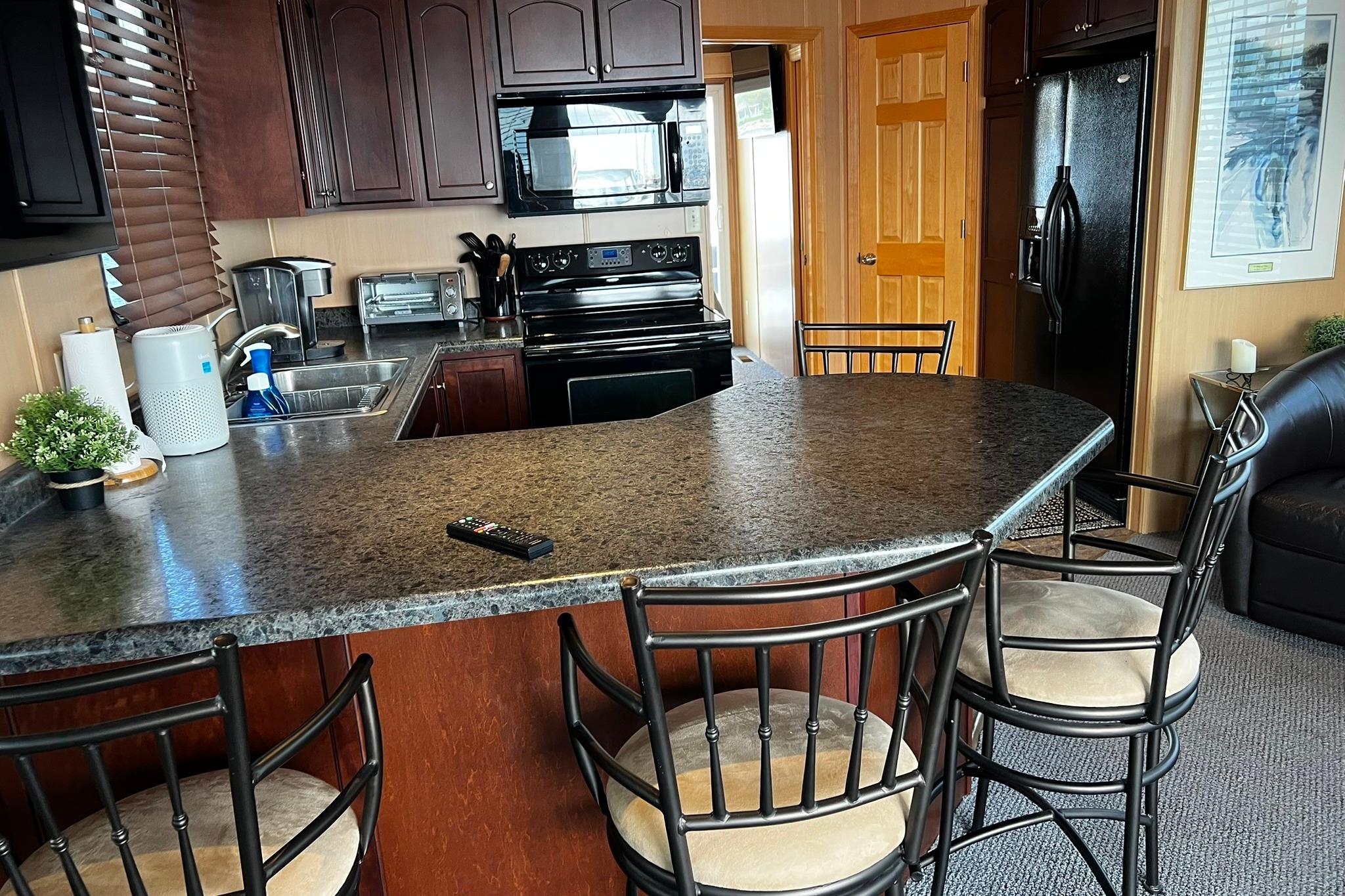 Modern kitchen interior on a 2010 Skipperliner 480 Flybridge yacht with bar seating.
