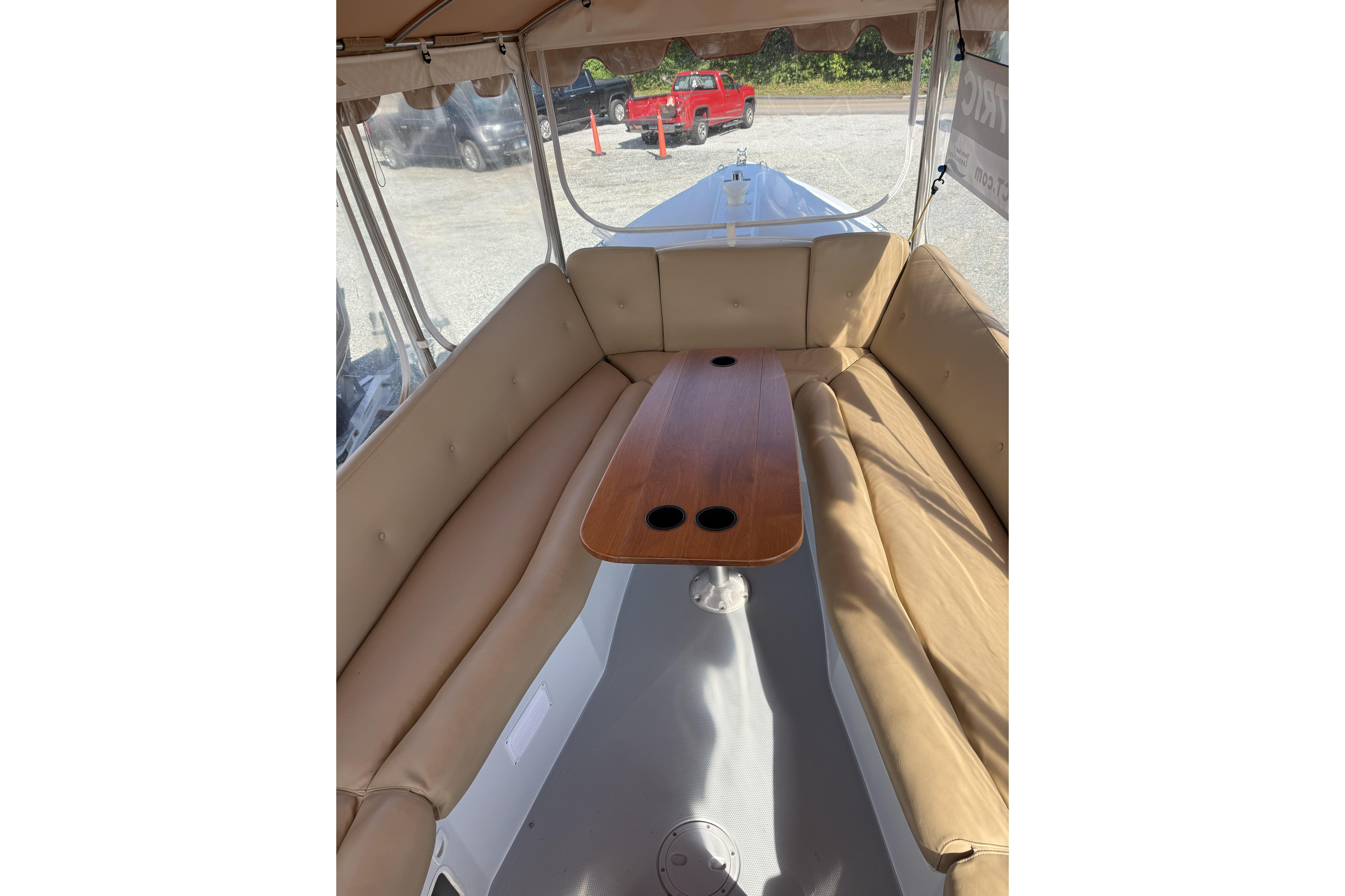 Interior of a 2004 Duffy 21 Classic boat with beige seating and wooden table.