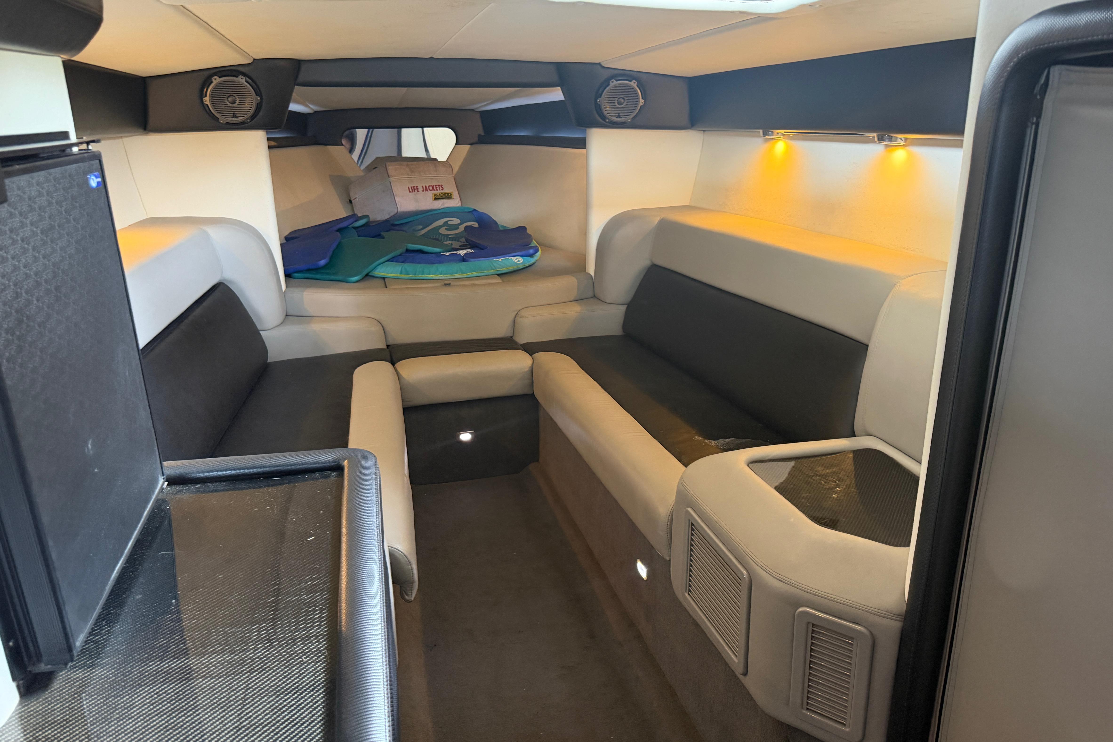 Luxurious interior of a 2013 Nor-Tech 477 SPX Vee Bottom boat with seating and ambient lighting.