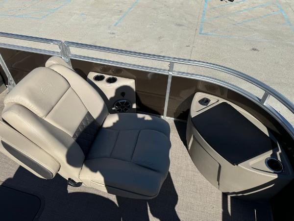 2025 Sun Tracker 24 Sportfish XP3 boat interior with beige seating and cup holders.