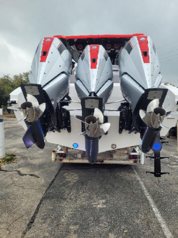 2024 Fountain 38 SCX boat with triple outboard engines, parked on a trailer.