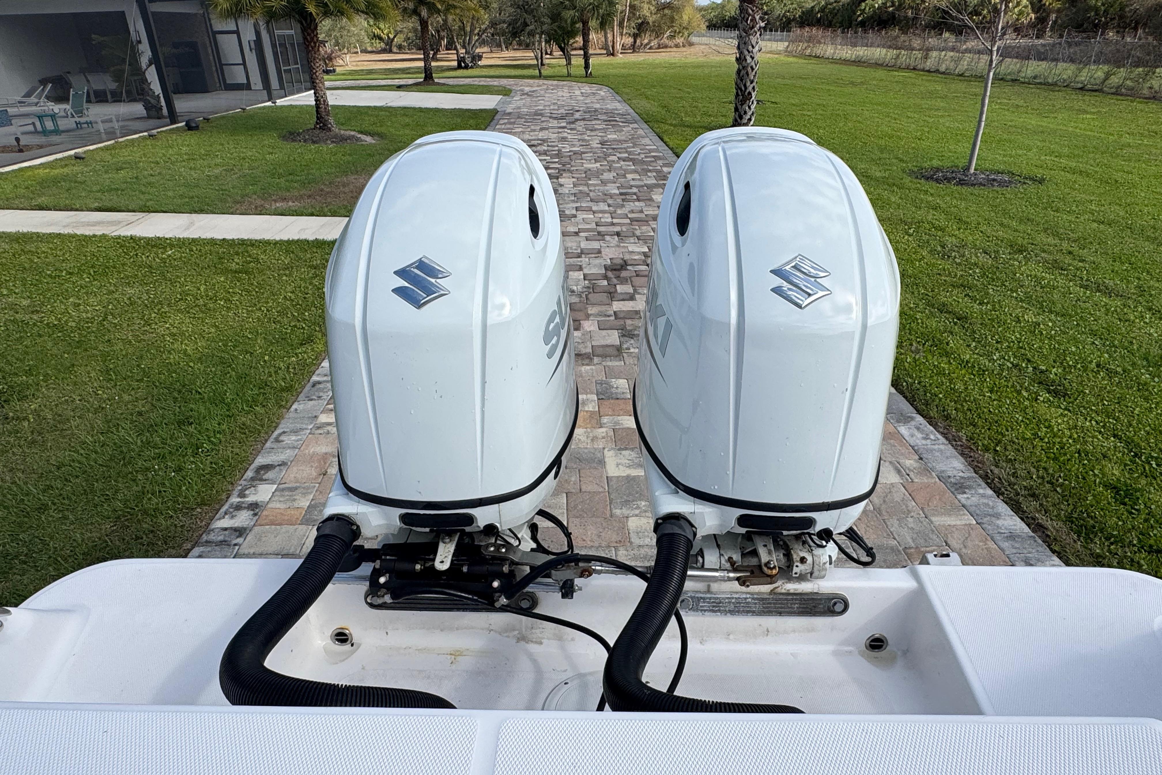 Twin Suzuki outboard motors on a 2022 Aquasport 2500 Center Console boat.