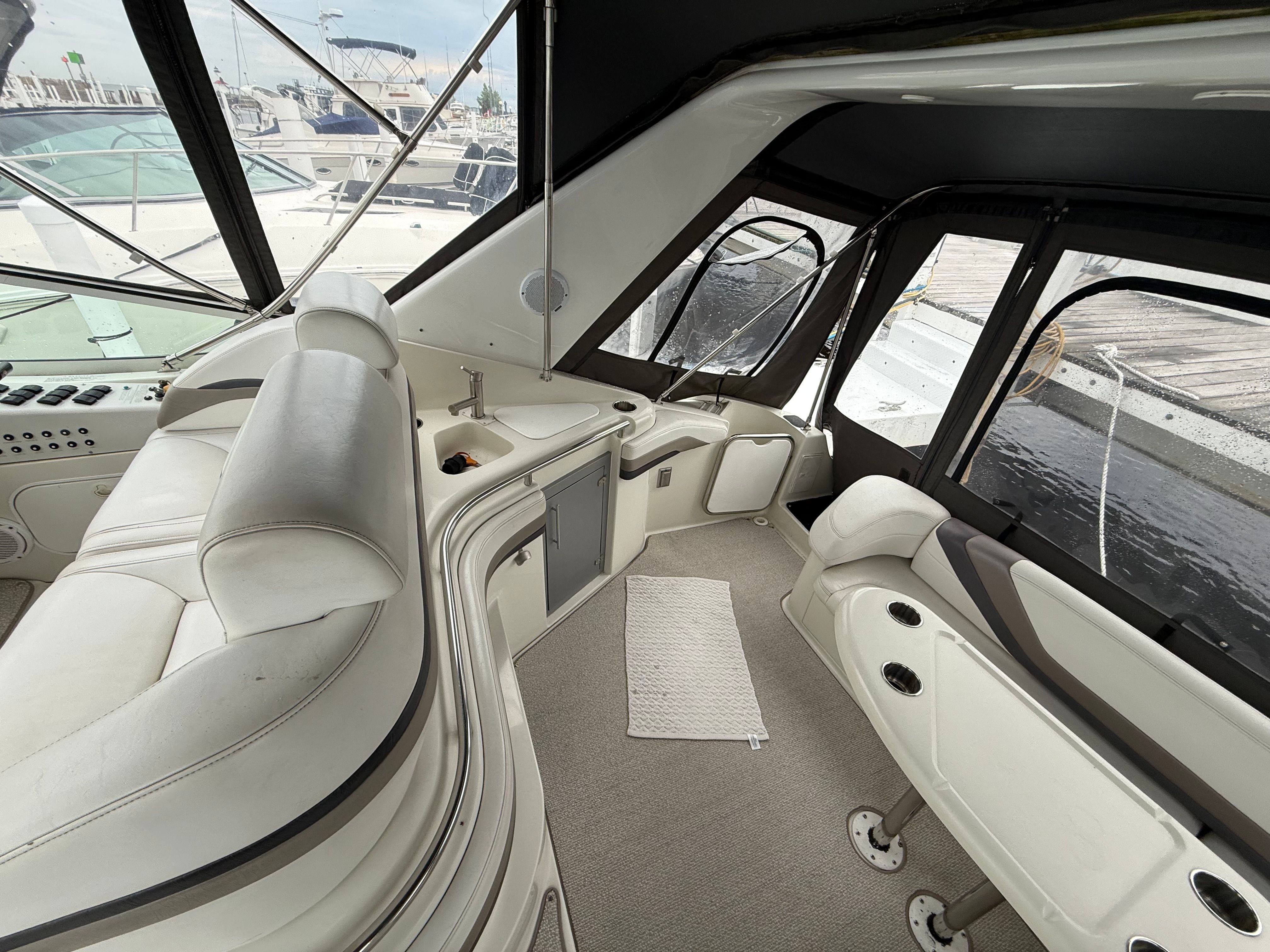 Interior of a 1995 Silverton 360 yacht with white seating and a sink.