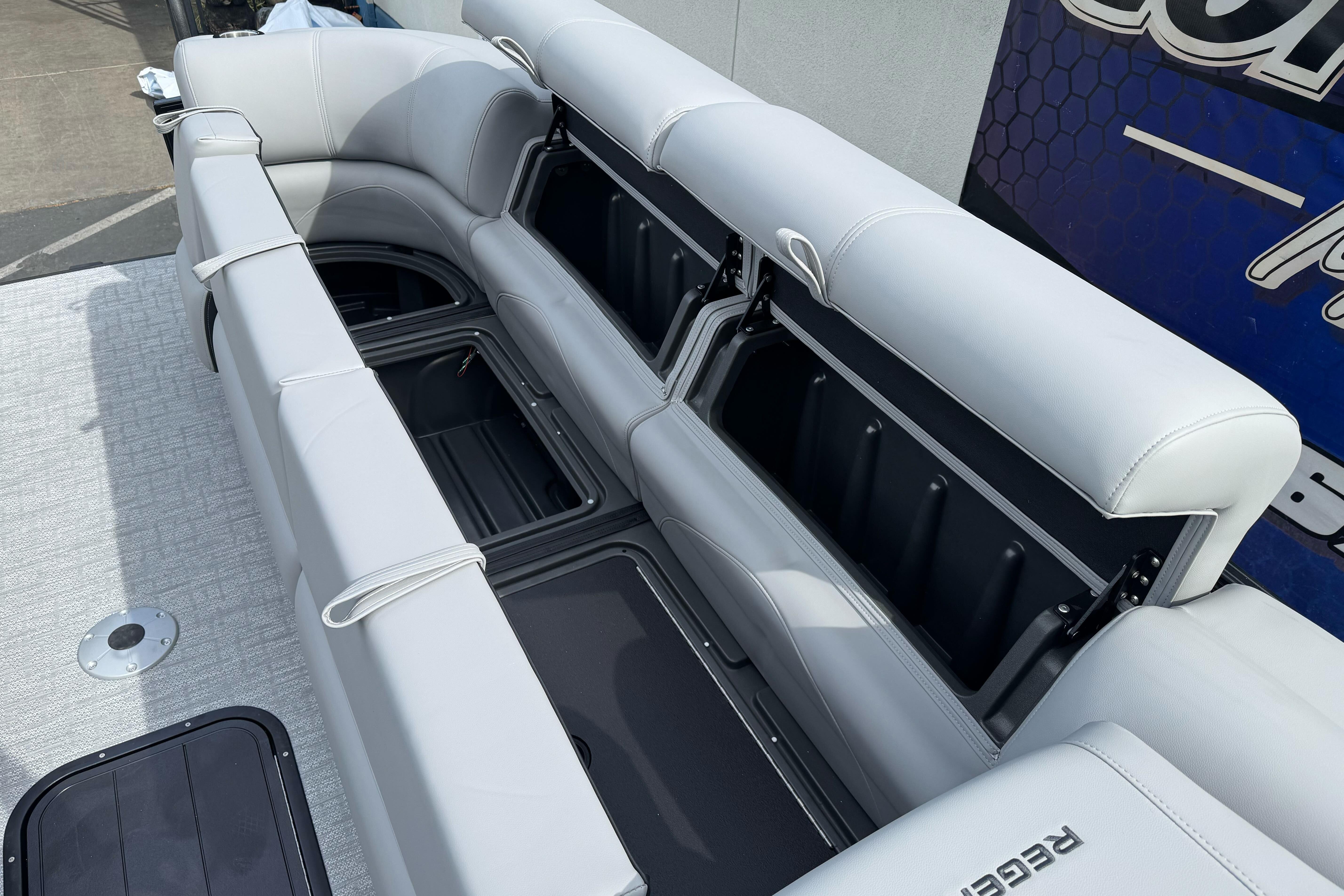 Luxurious seating with storage on 2026 Regency 250 DL boat, featuring sleek design and comfort.