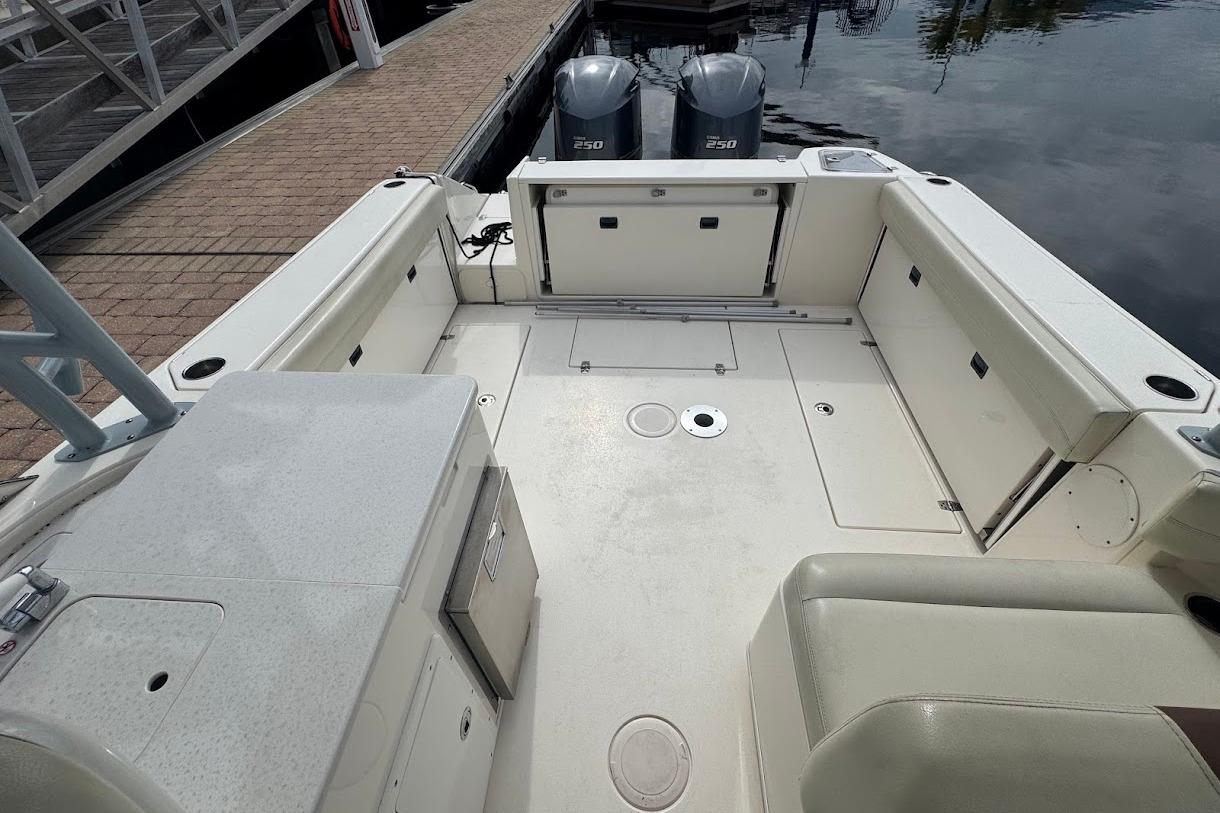 2020 Cobia 280 Dual Console boat interior with spacious seating and twin engines at dock.