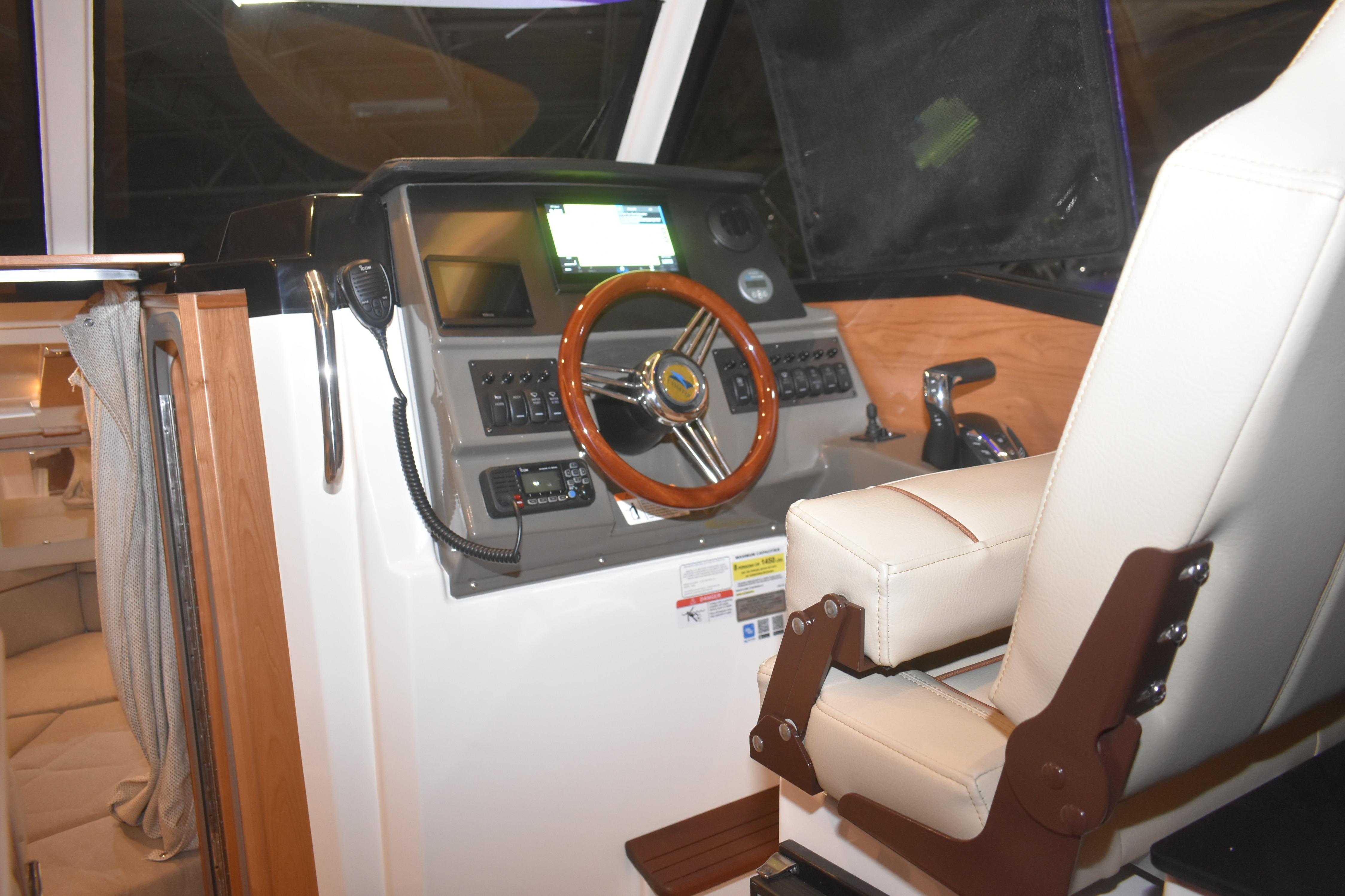 2026 Cutwater C-248 Coupe helm with modern controls and comfortable captain's chair.