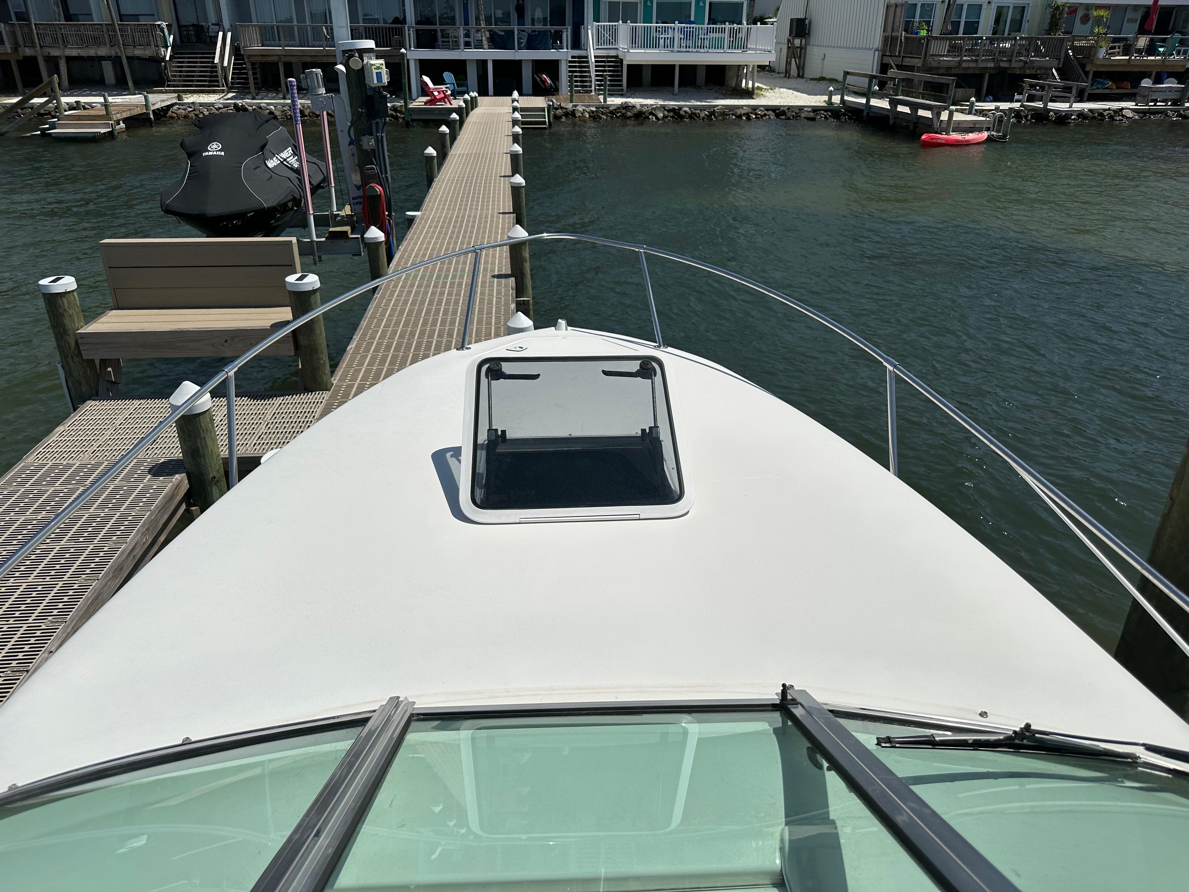 1998 Sea Ray 240 Sundancer docked at marina, view from bow.