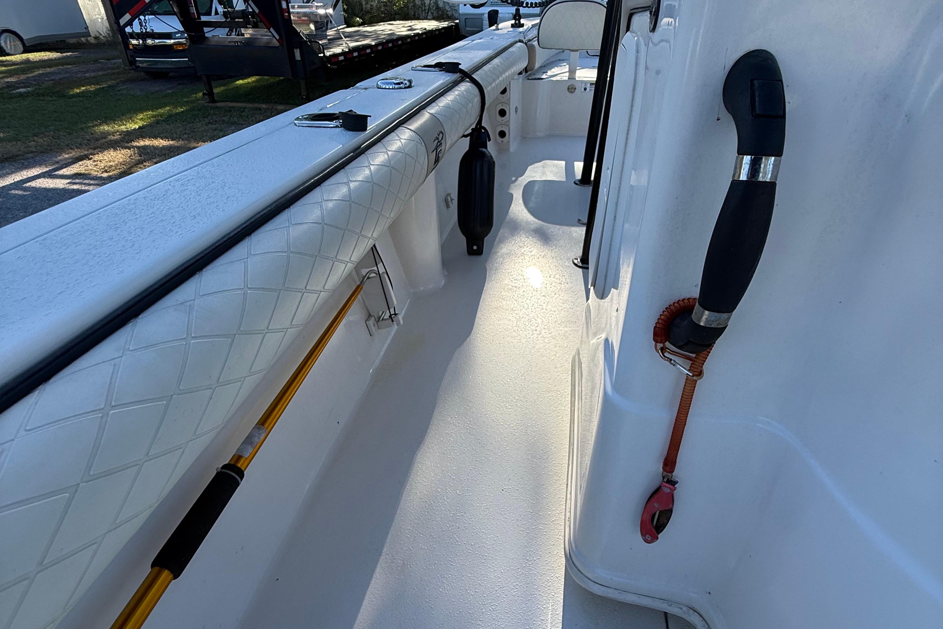 2021 Carolina Skiff 26 Ultra Elite boat interior with rod holder and cushioned side panel.